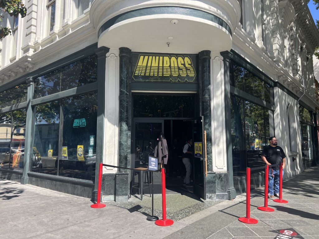 Exterior of MINIBOSS, with the entrance, signage and storefront visible from the street.