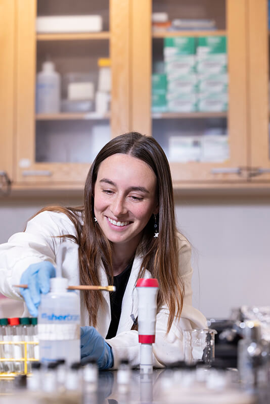 Julianna Colucci works on her oyster restoration research in a lab. 