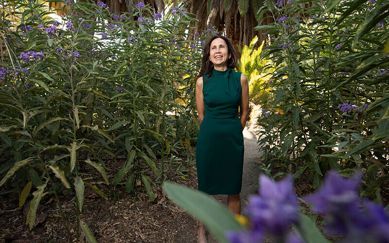 Joya Salas stands in flower field at the Arboretum and Botanical Garden at Cal State Fullerton