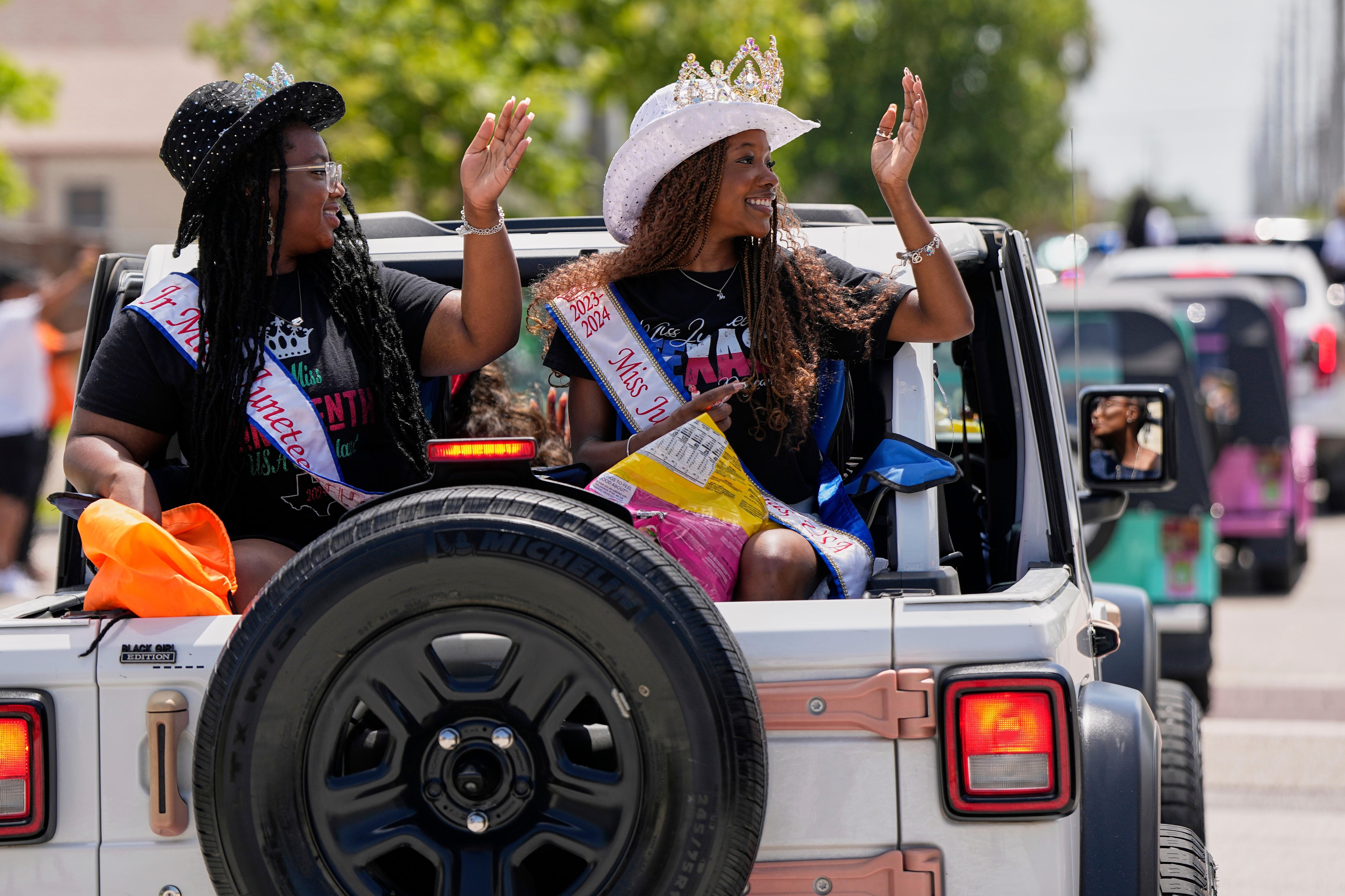 FILE – People participate during a Juneteenth parade, June 19,...