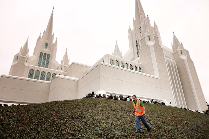A landscape worker puts the finishing touches on the grounds of the San Diego California Temple ahead of media day on Monday, June 15, 2026.