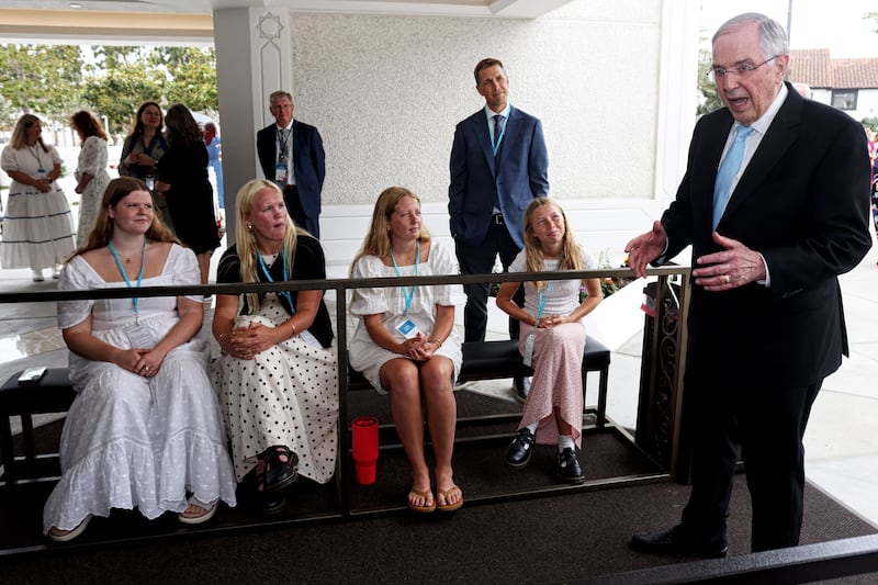 Elder Neil L. Andersen talks with youth volunteers in front of the newly renovated San Diego California Temple during media day on Monday, June 15, 2026.