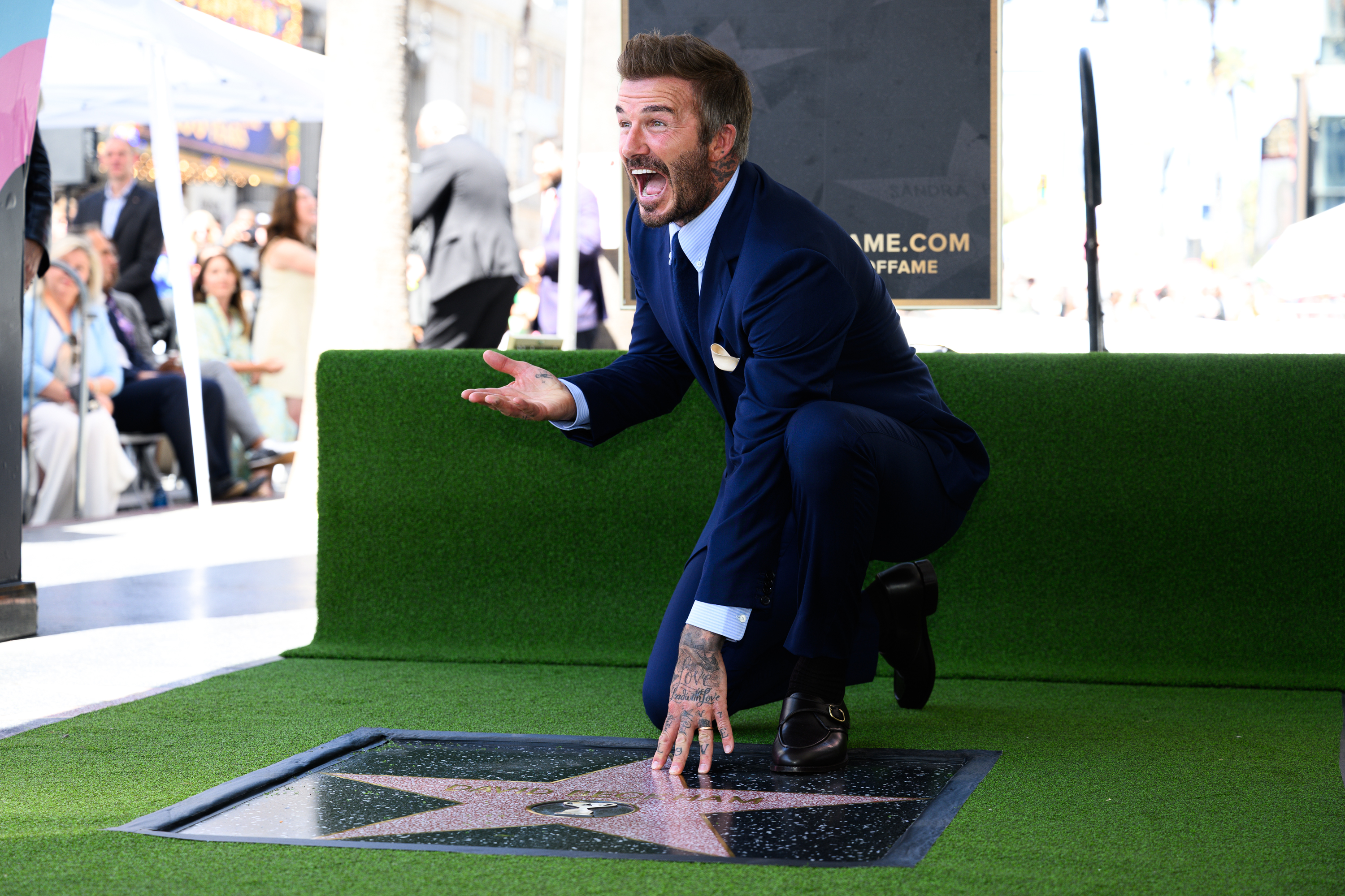 David Beckham poses with his new star on the Hollywood...