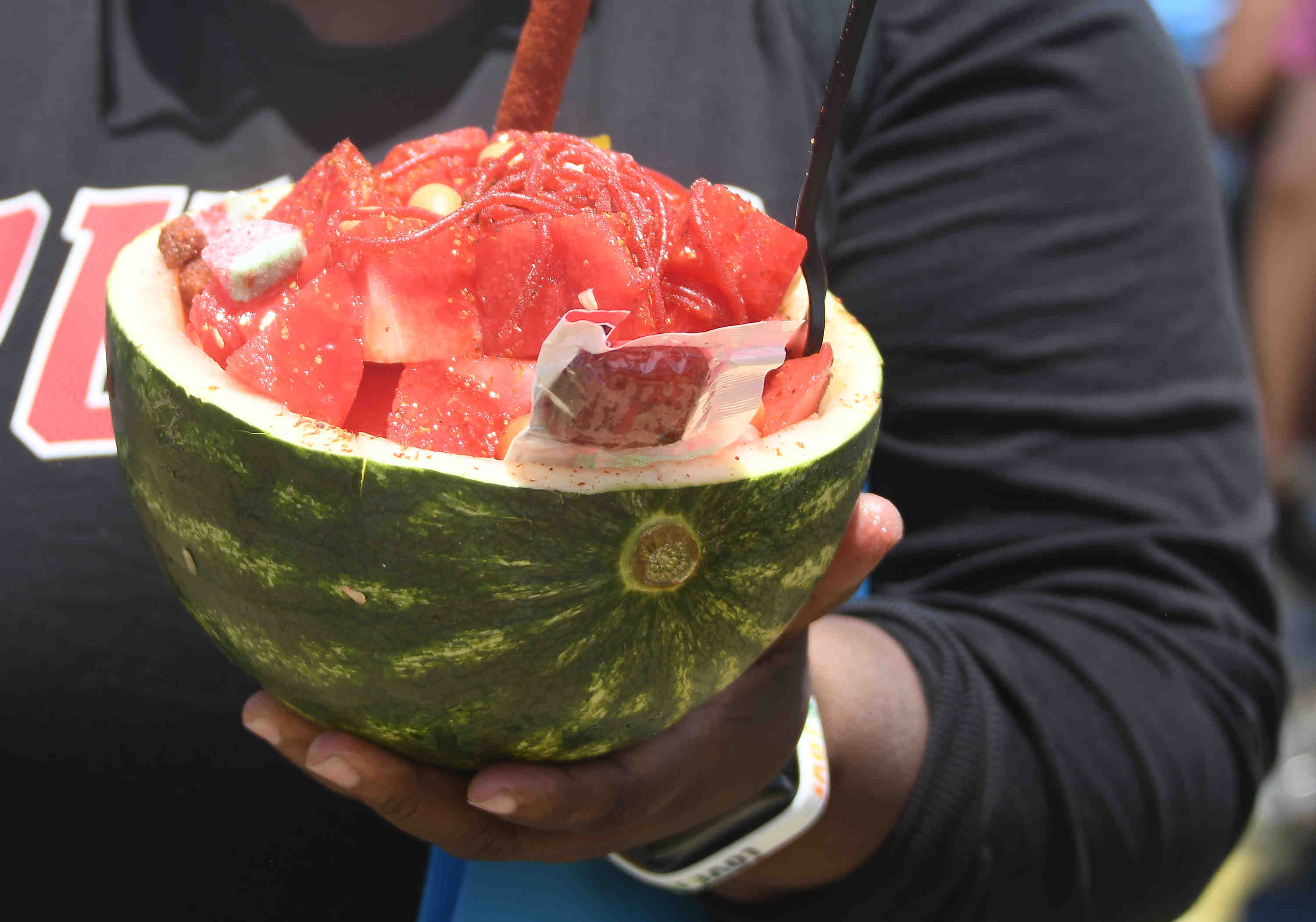 People enjoy watermelon bowls by Gourmet Churros during the California...