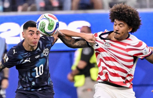 U.S. defender Chris Richards battles with Paraguay's Miguel Almirón during the second half of their World Cup match on Friday night. (Photo by Keith Birmingham, SCNG)