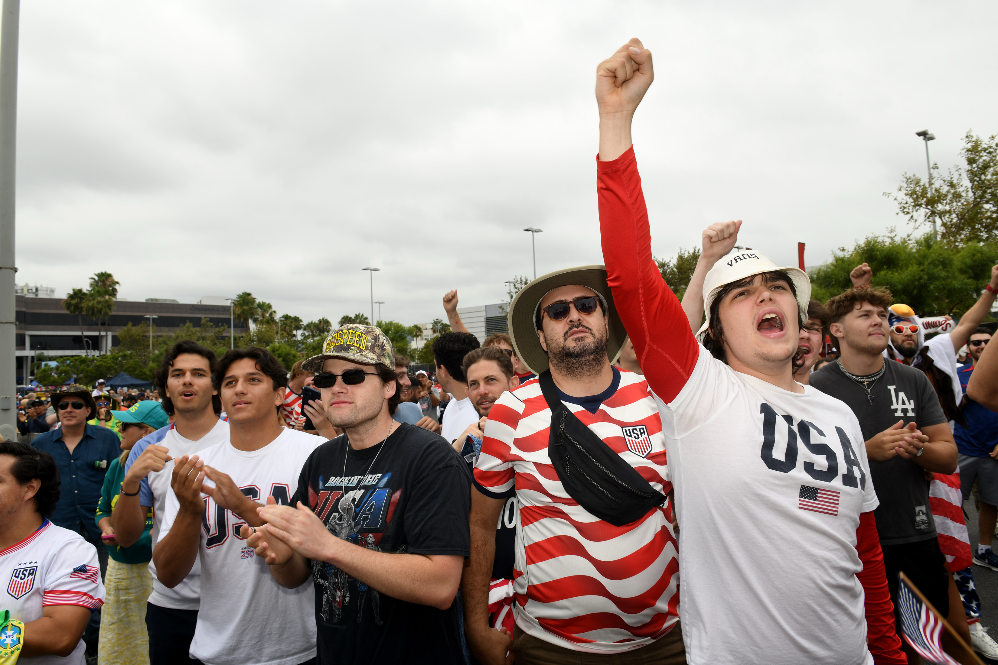 Levi Dokus and his friends cheer their team as the...