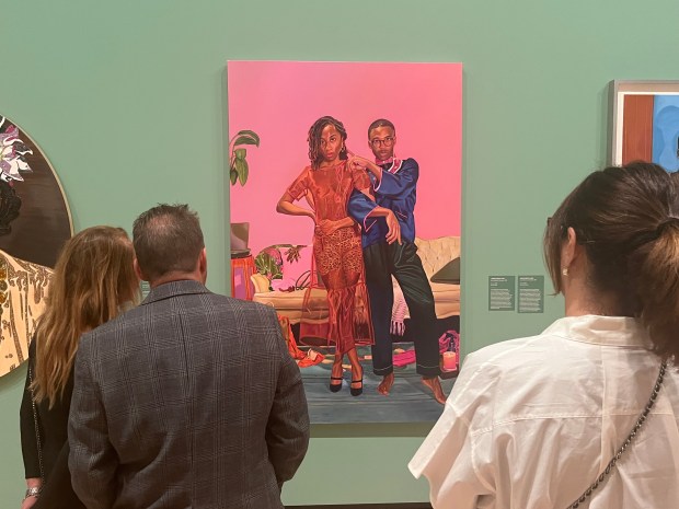 Guests view Jarvis Boyland's painting "Pop Out" as part of the Museum of Contemporary Art San Diego's "Giants" exhibition. (Noah Lyons)