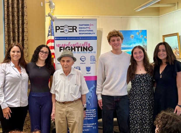 PeerK12 co-founder Tamar Caspi, scholarship winner Isabel Vann, Holocaust survivor Ben Midler, scholarship winners Jack Norman and Abigail Weisman and PeerK12 co-founder Nicole Bernstein gather at the La Jolla/Riford Library on June 9. (PeerK12)