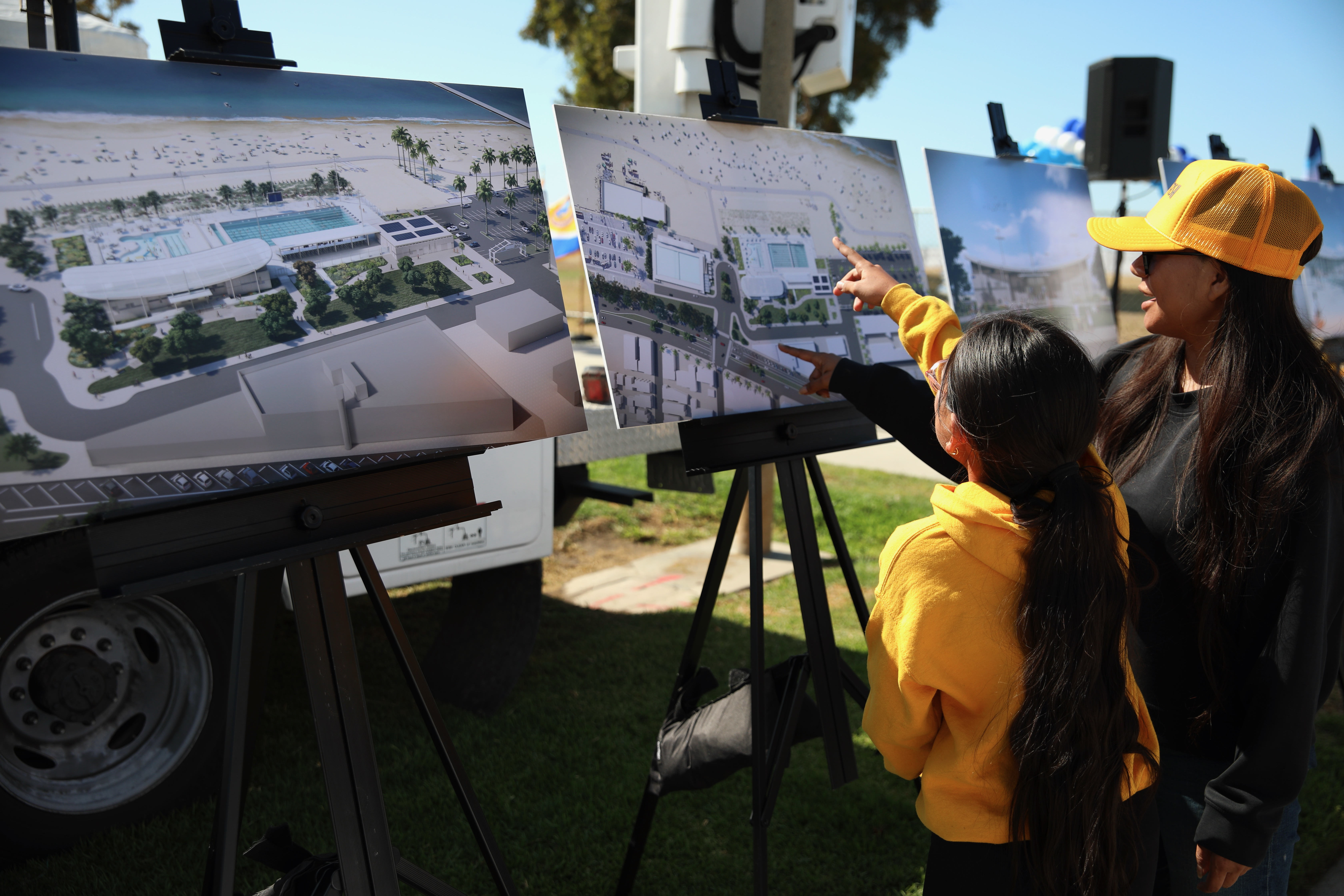 Guests look at renderings of the future Belmont Plaza Pool...