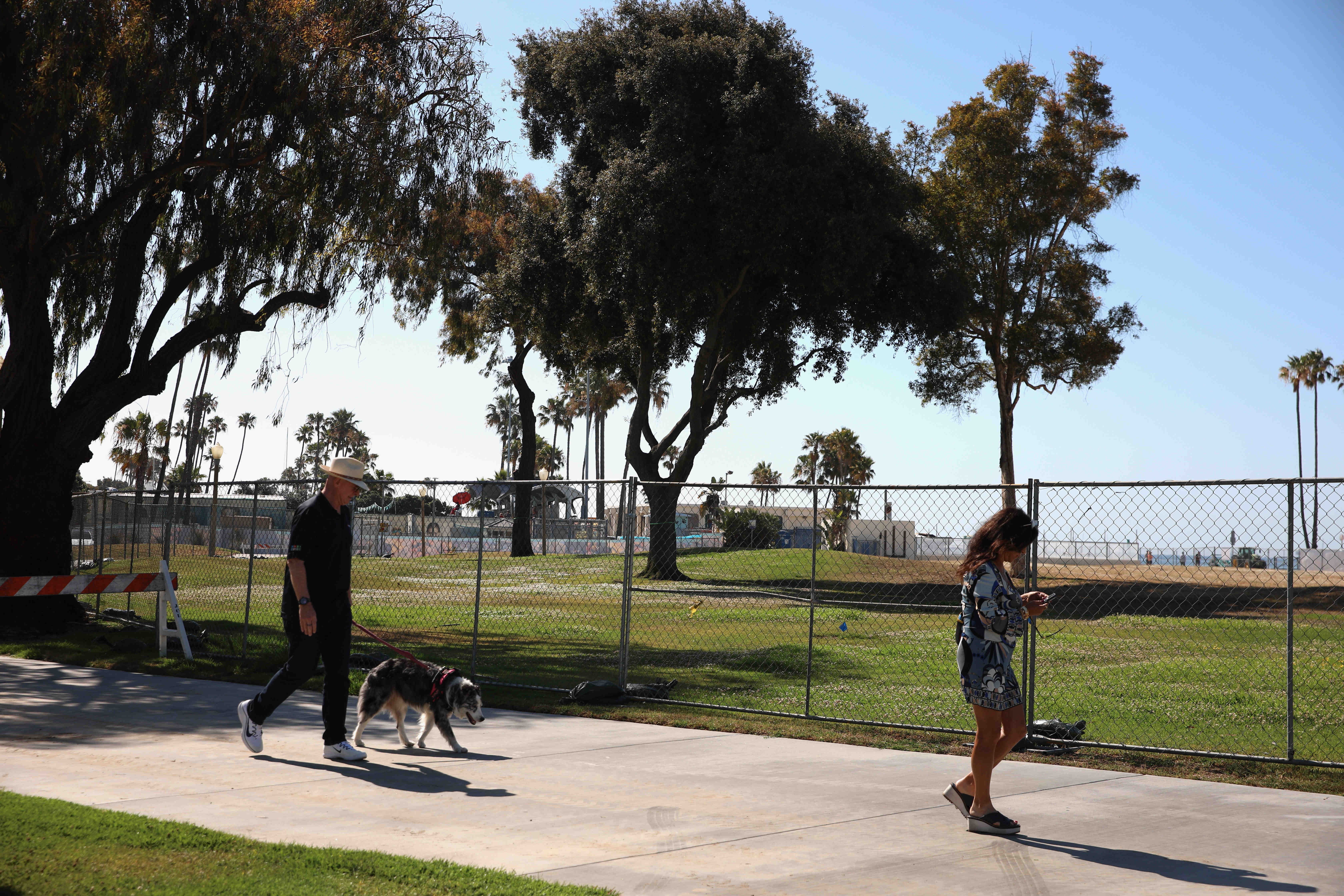 People walk passed the site of the future Belmont Plaza...