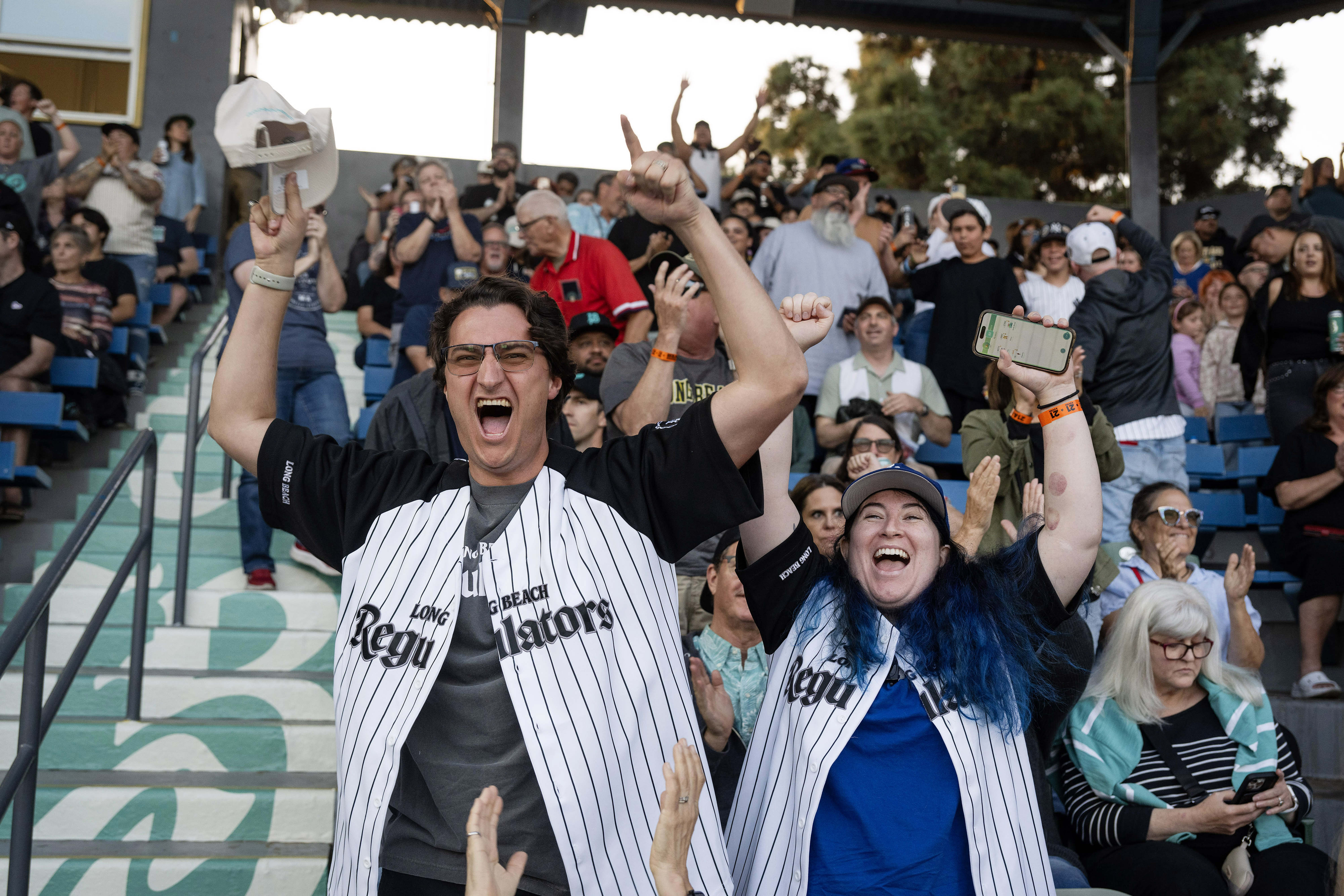 From left, Travis and Denise Baker cheer for Long Beach...