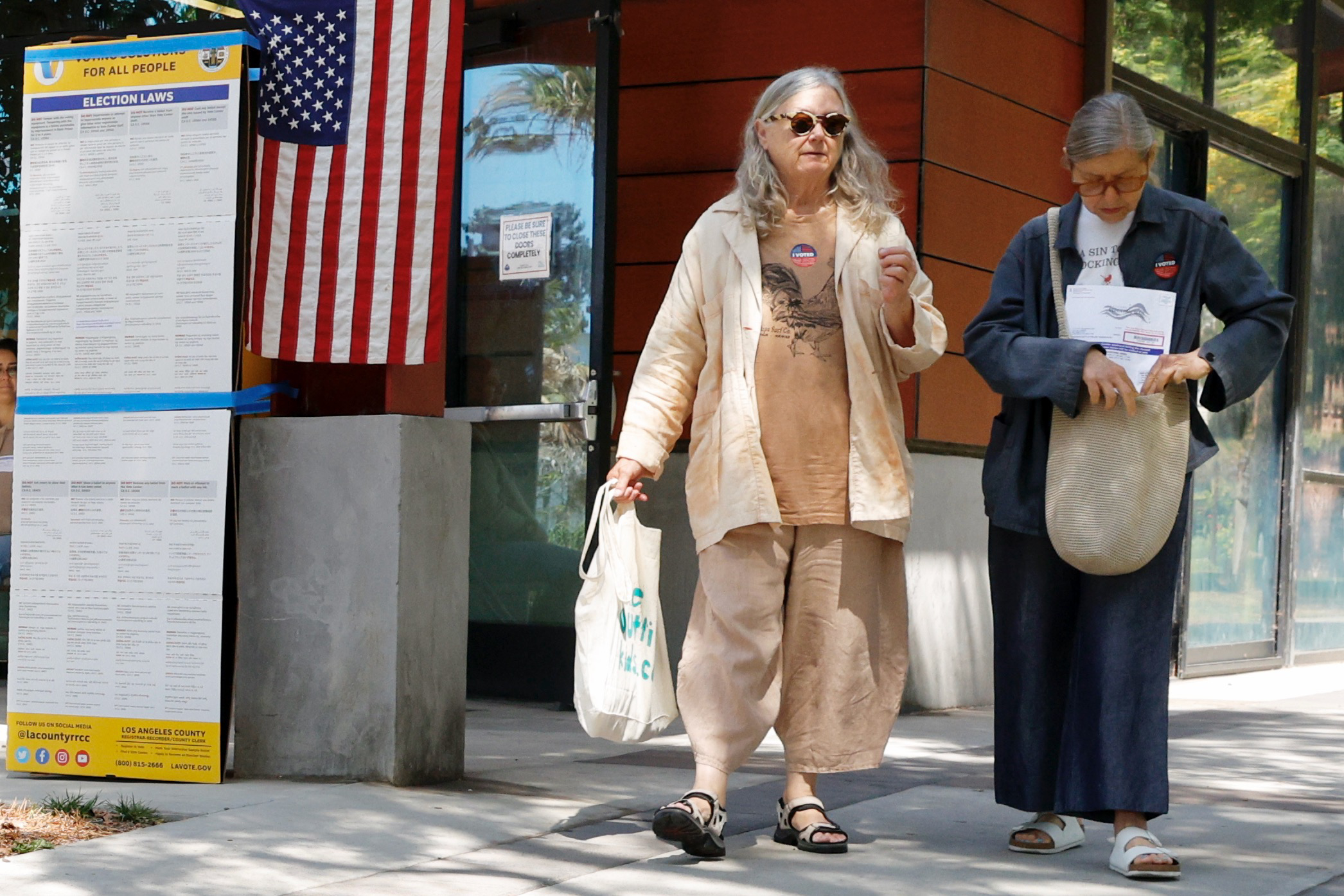 Voters donning âI votedâ stickers exit Long Beach’s Orizaba Park...