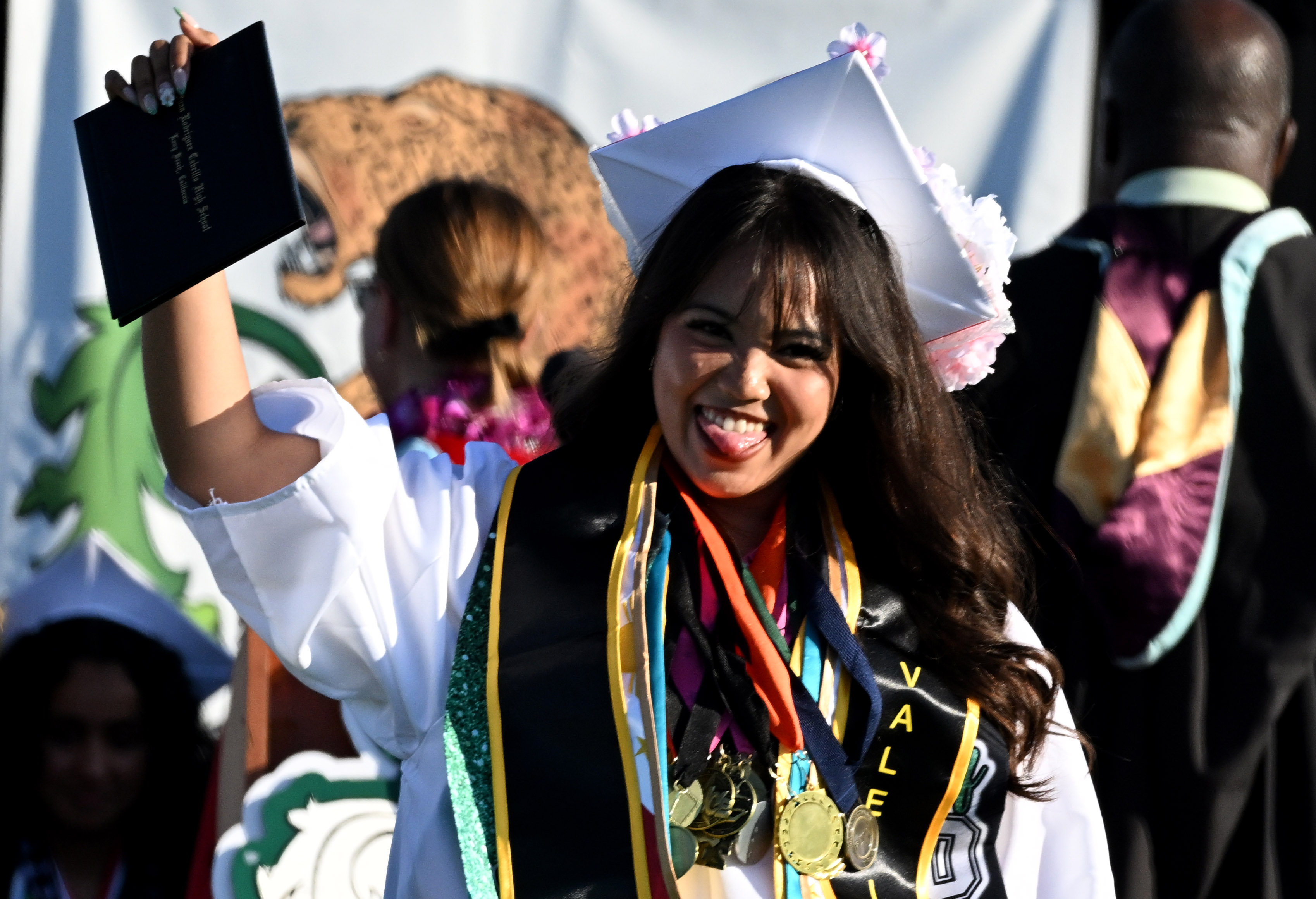 A senior smiles after receiving her diploma during the 2026...
