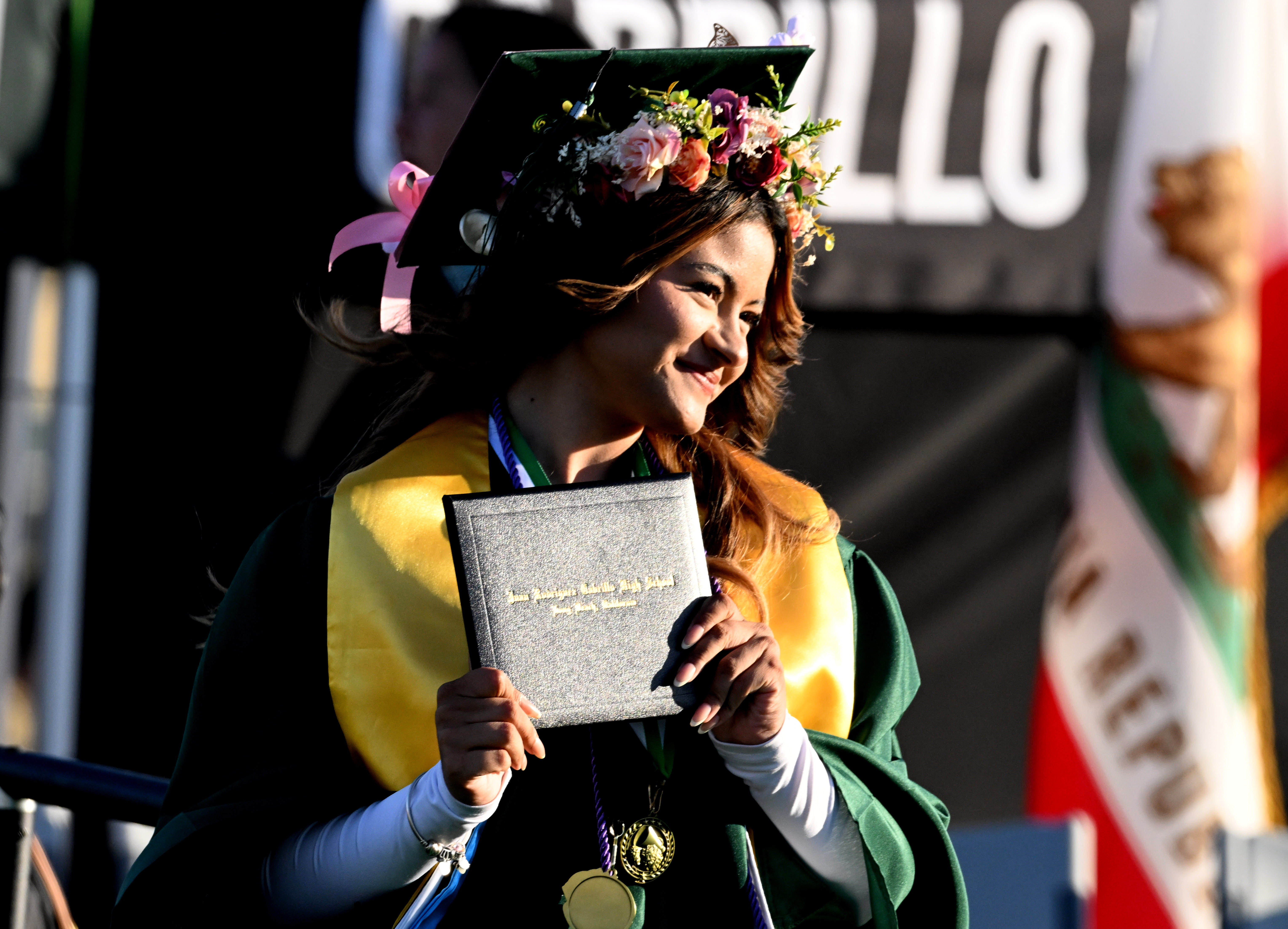 A senior smiles after receiving her diploma during the 2026...