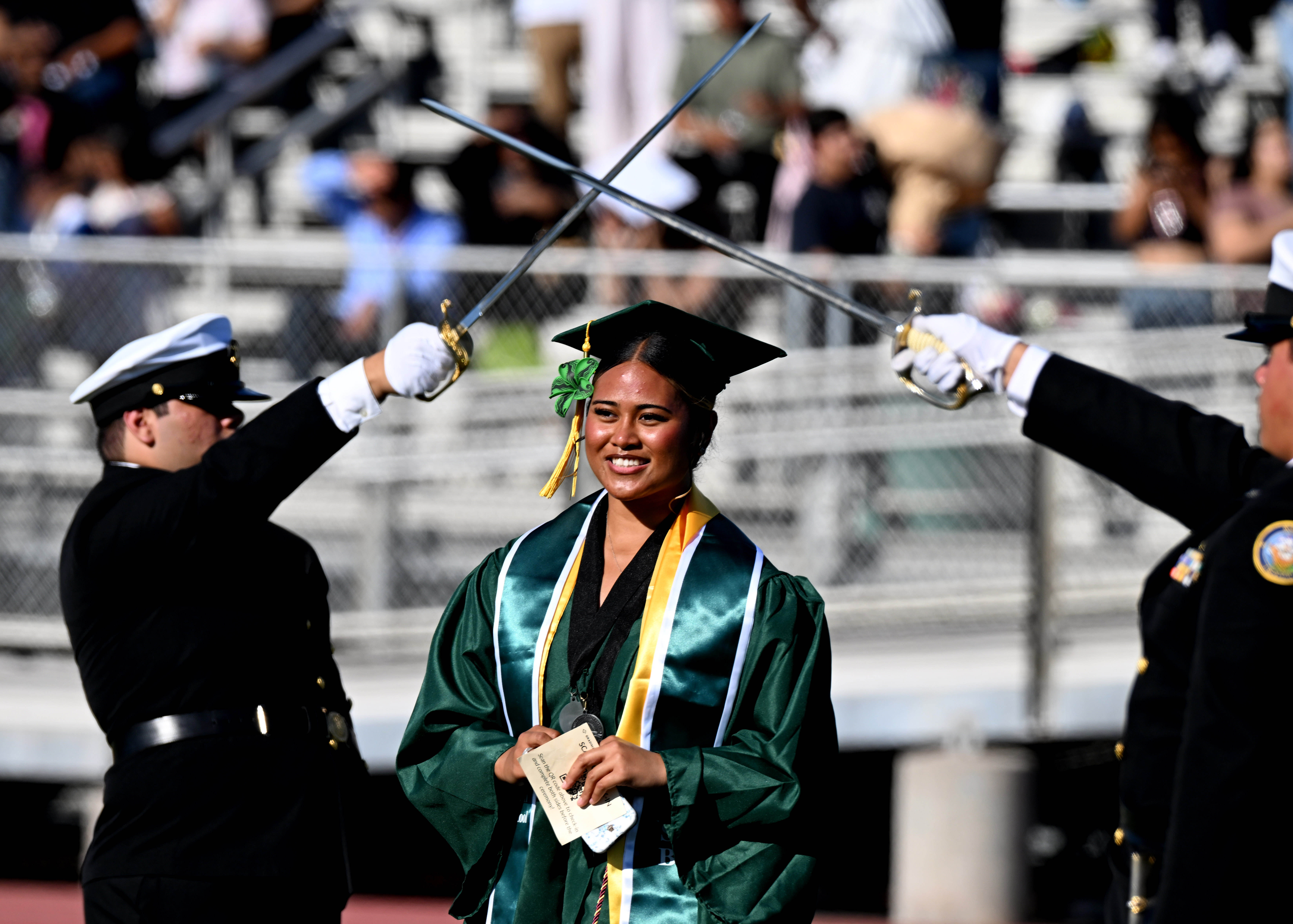 Senior Speaker Kyra Tepa Taunaloto walks though the honor guard...