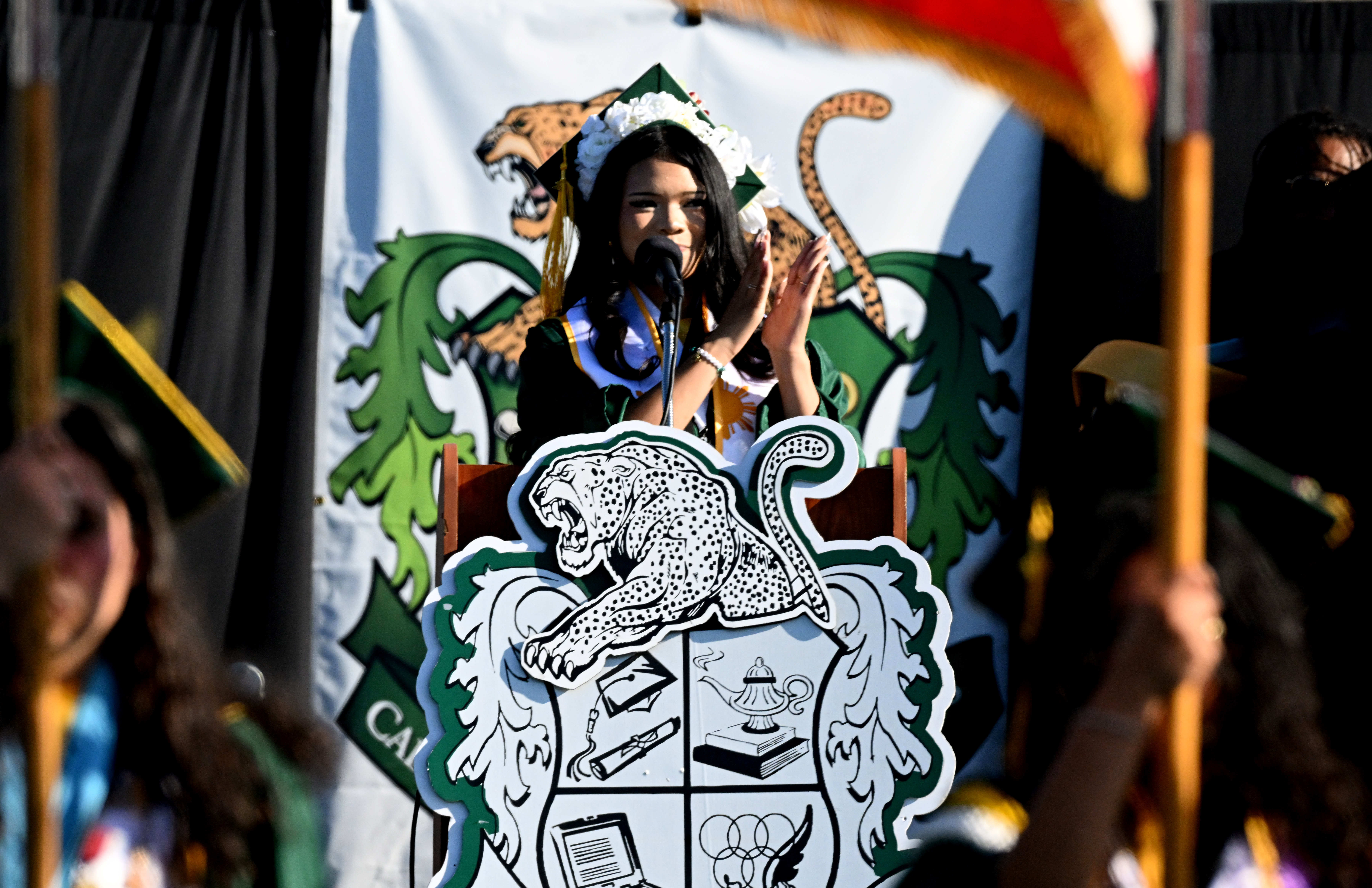 Senior Class President Samantha Rodriguez leads the crowd in the...