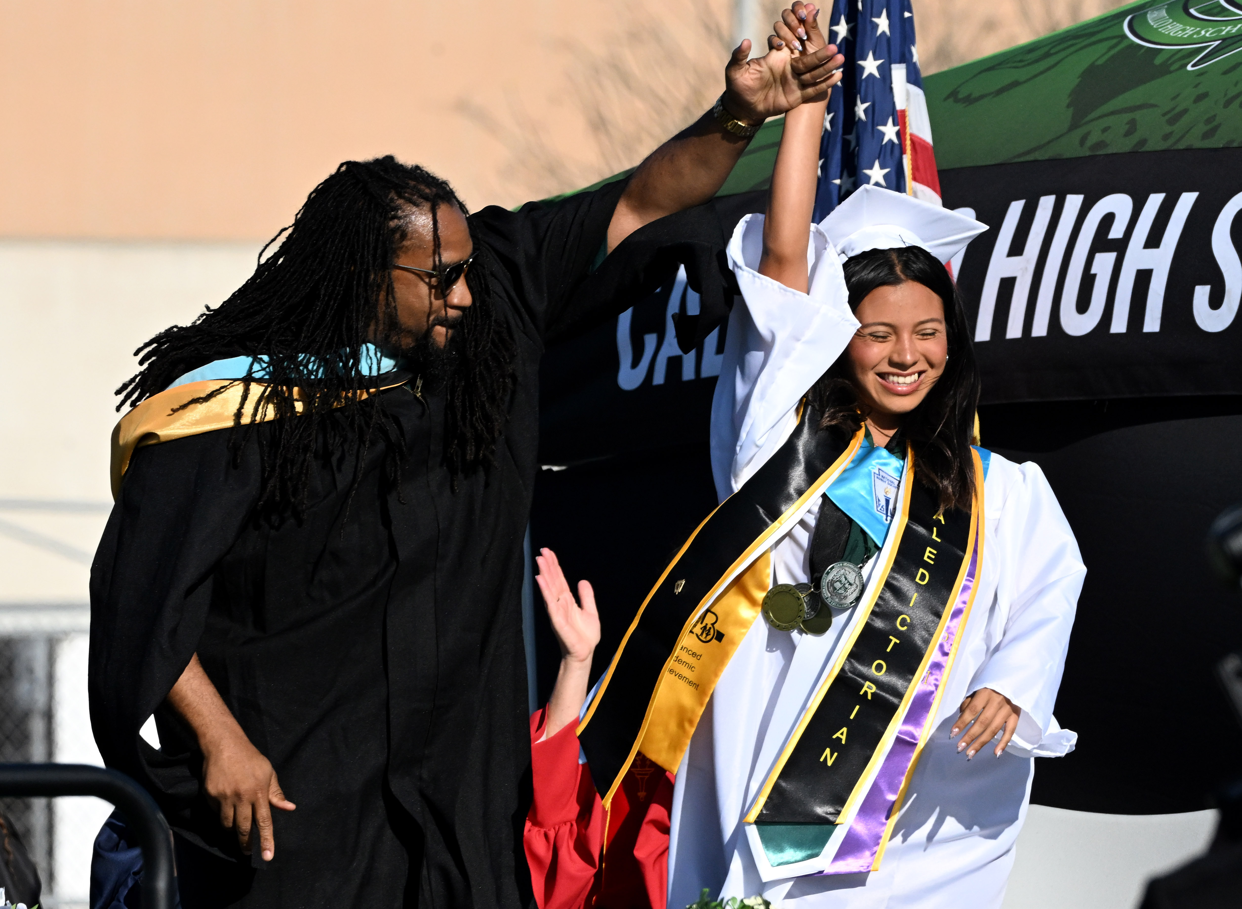 Assistant Principal George Walton dances with Emcee Flor Garibay as...