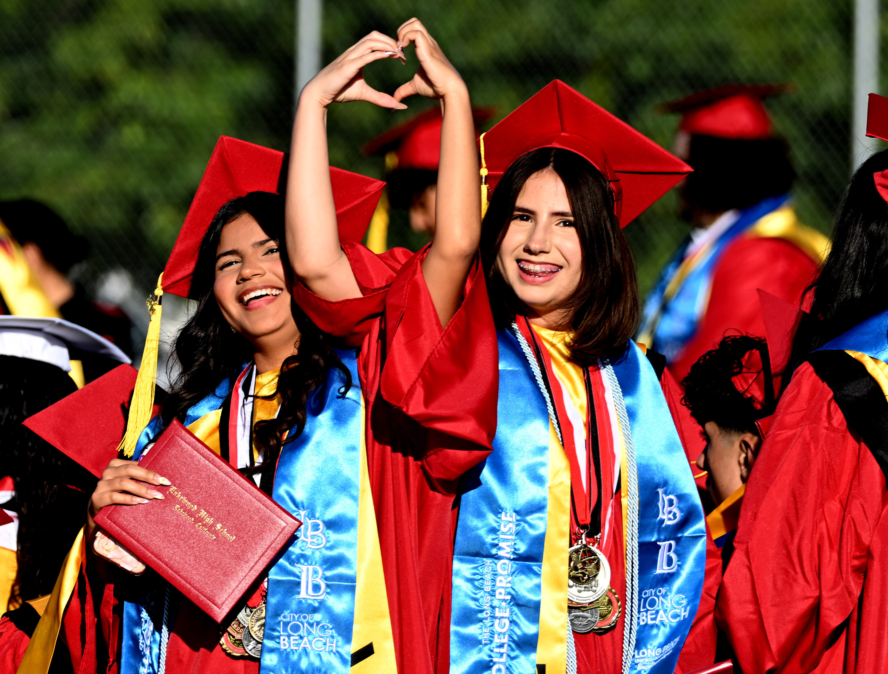 Seniors Victoria Martinez, left, and Celeste Martinez, right, make a...