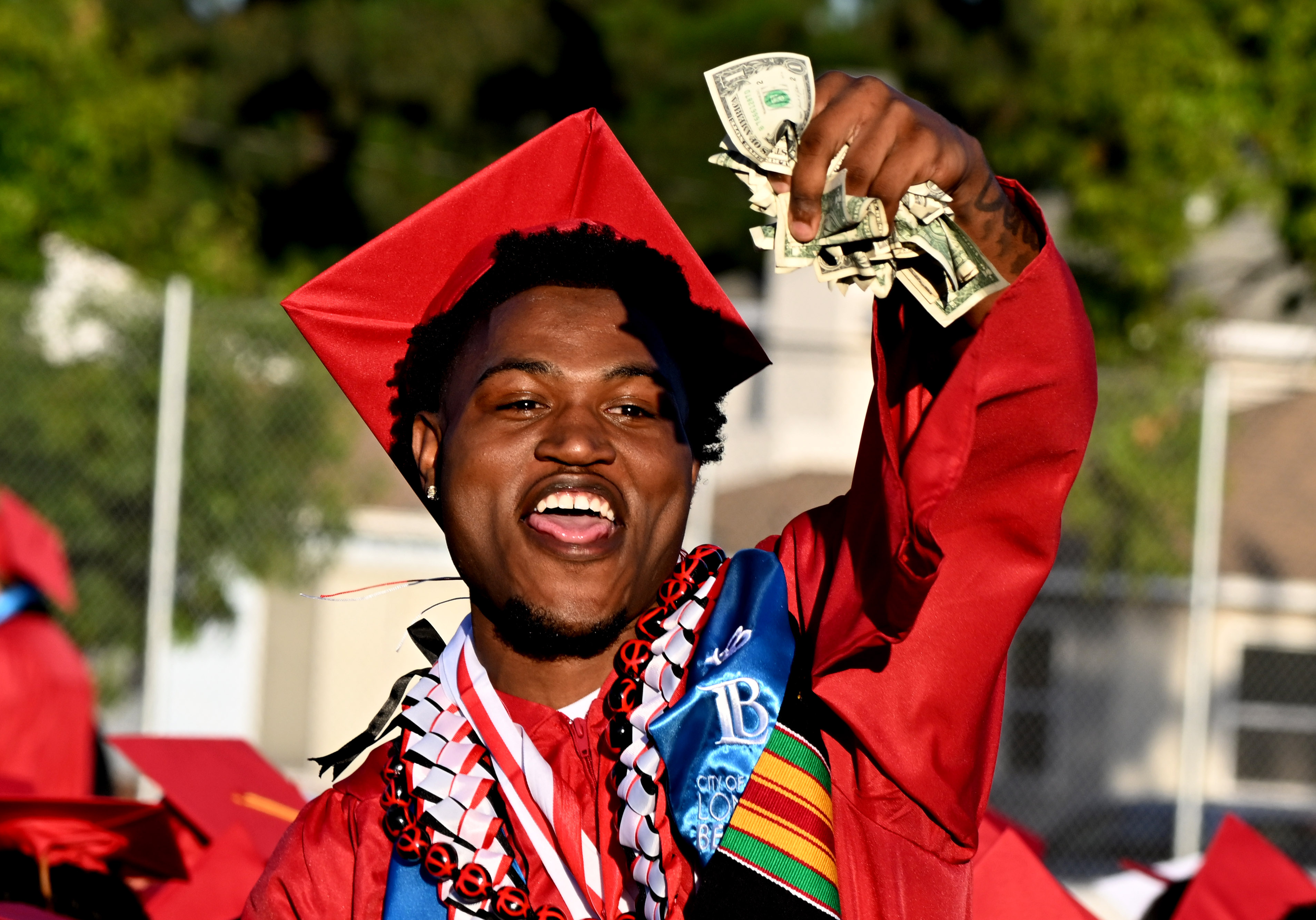 A senior shows off money he picked up after a...