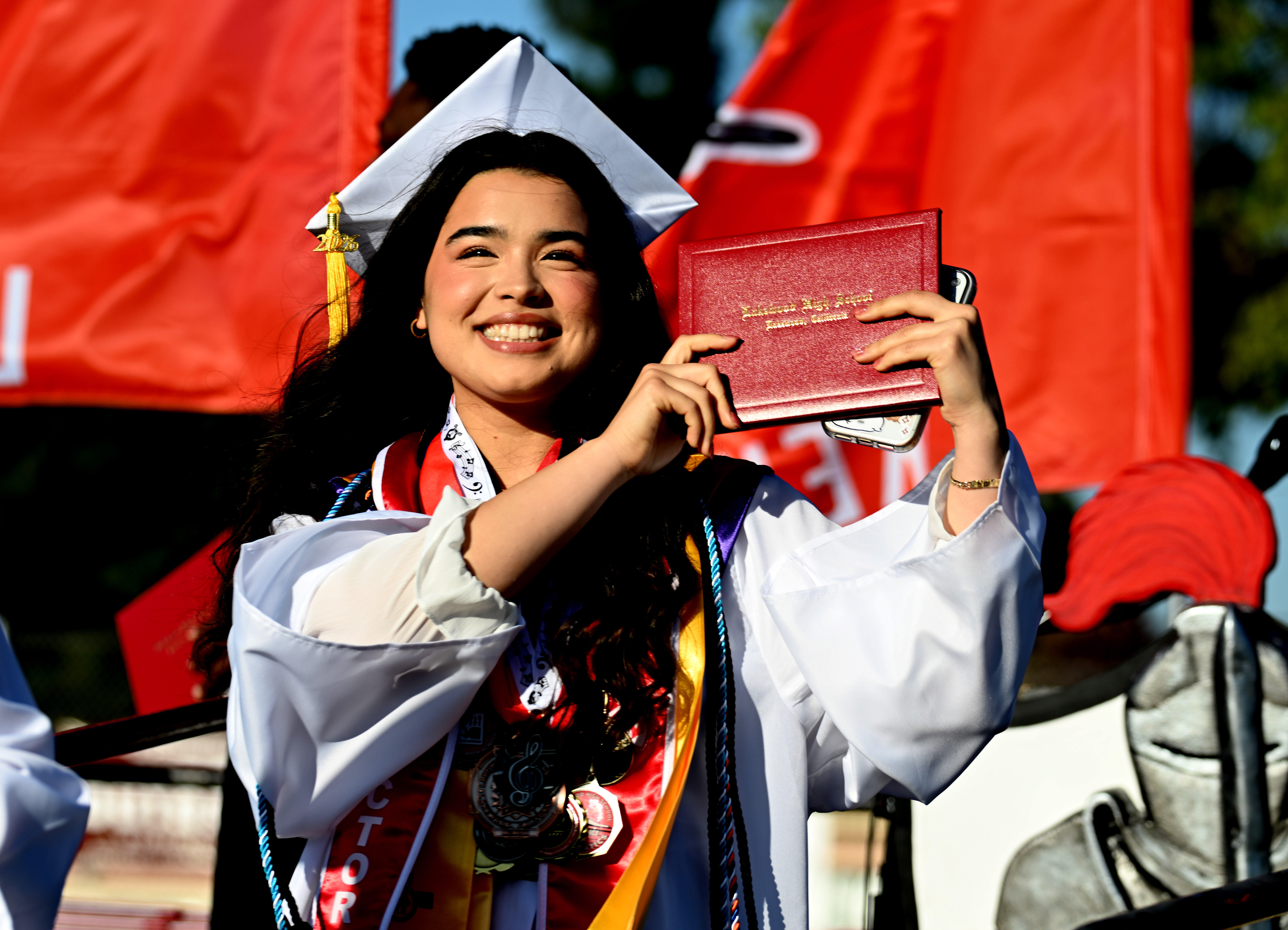 A senior reacts after receiving her diploma during the 2026...