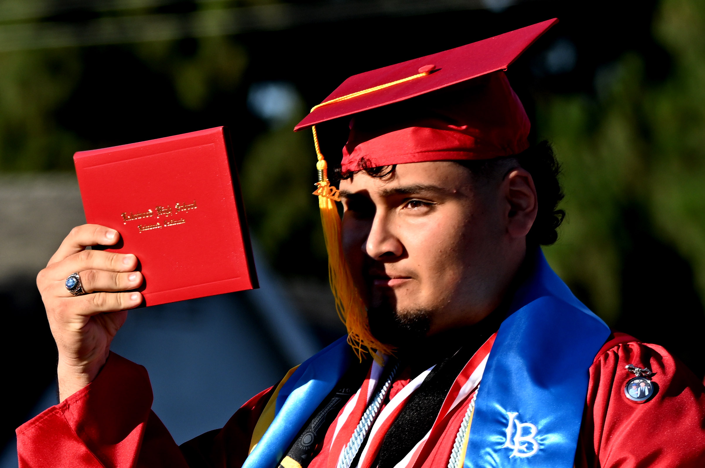A senior reacts after receiving his diploma during the 2026...