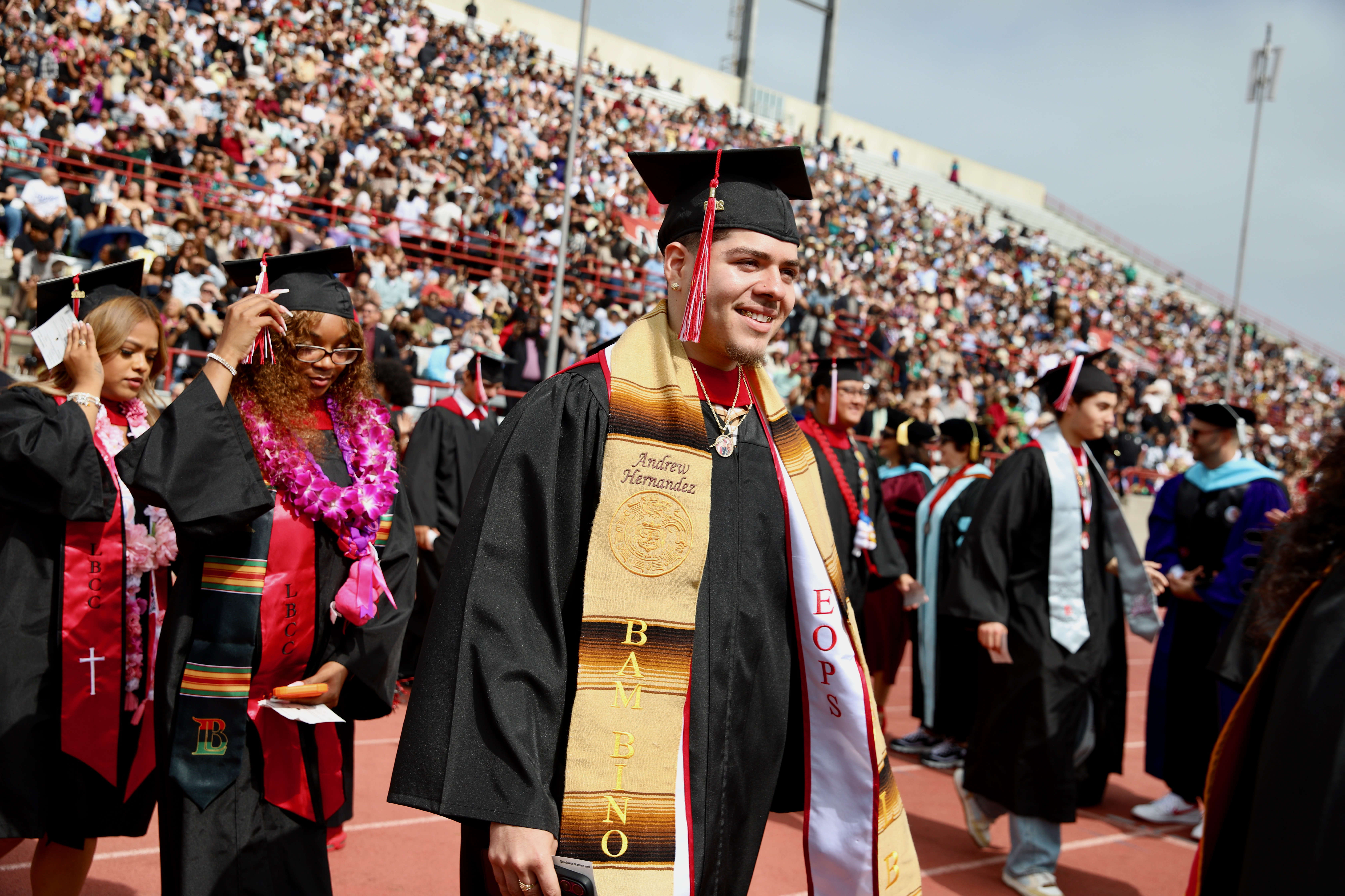 Graduating students enter the field to loud cheers at Long...