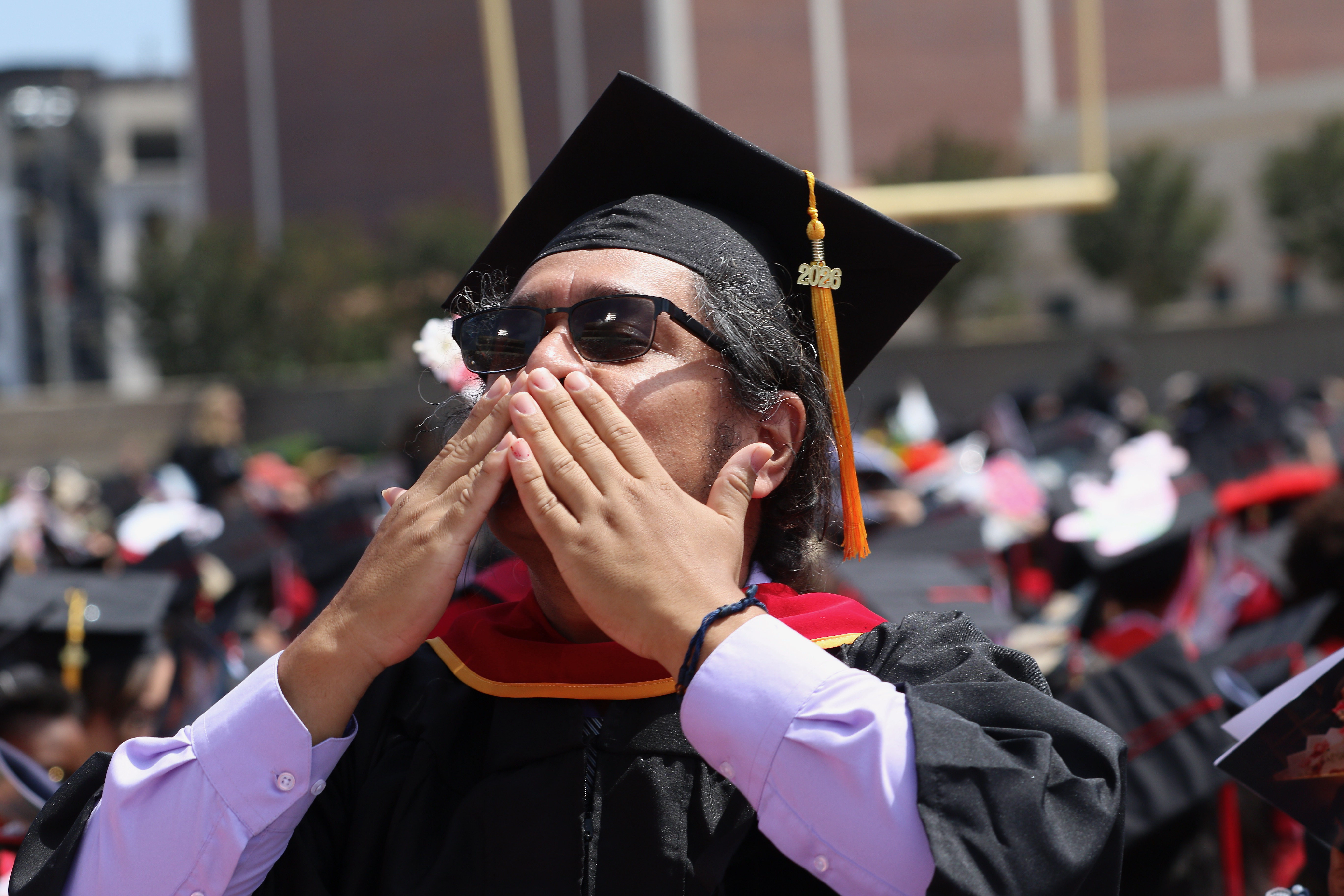 A graduating student sends some love towards the crowd at...