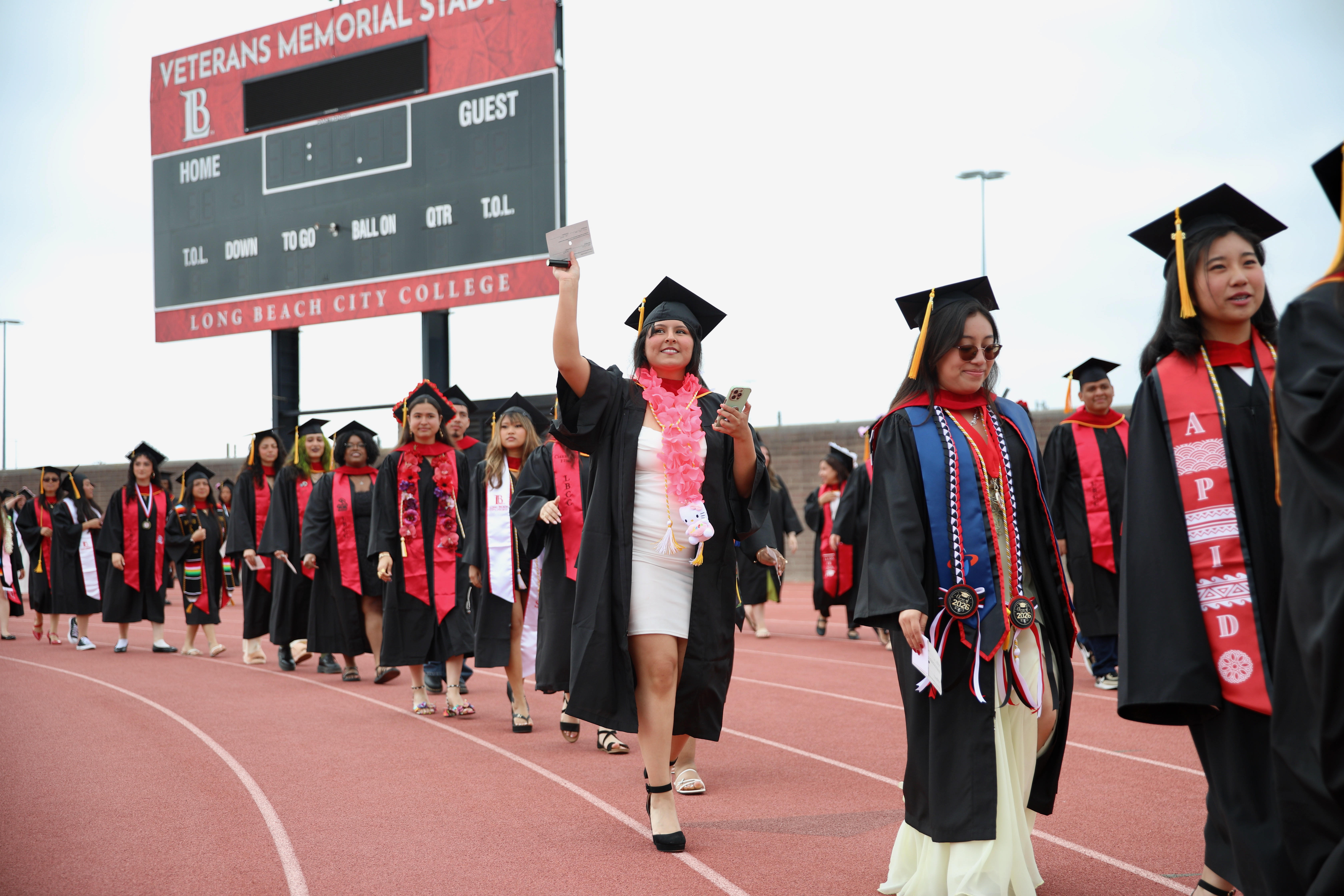 Graduating students enter the field to loud cheers at Long...