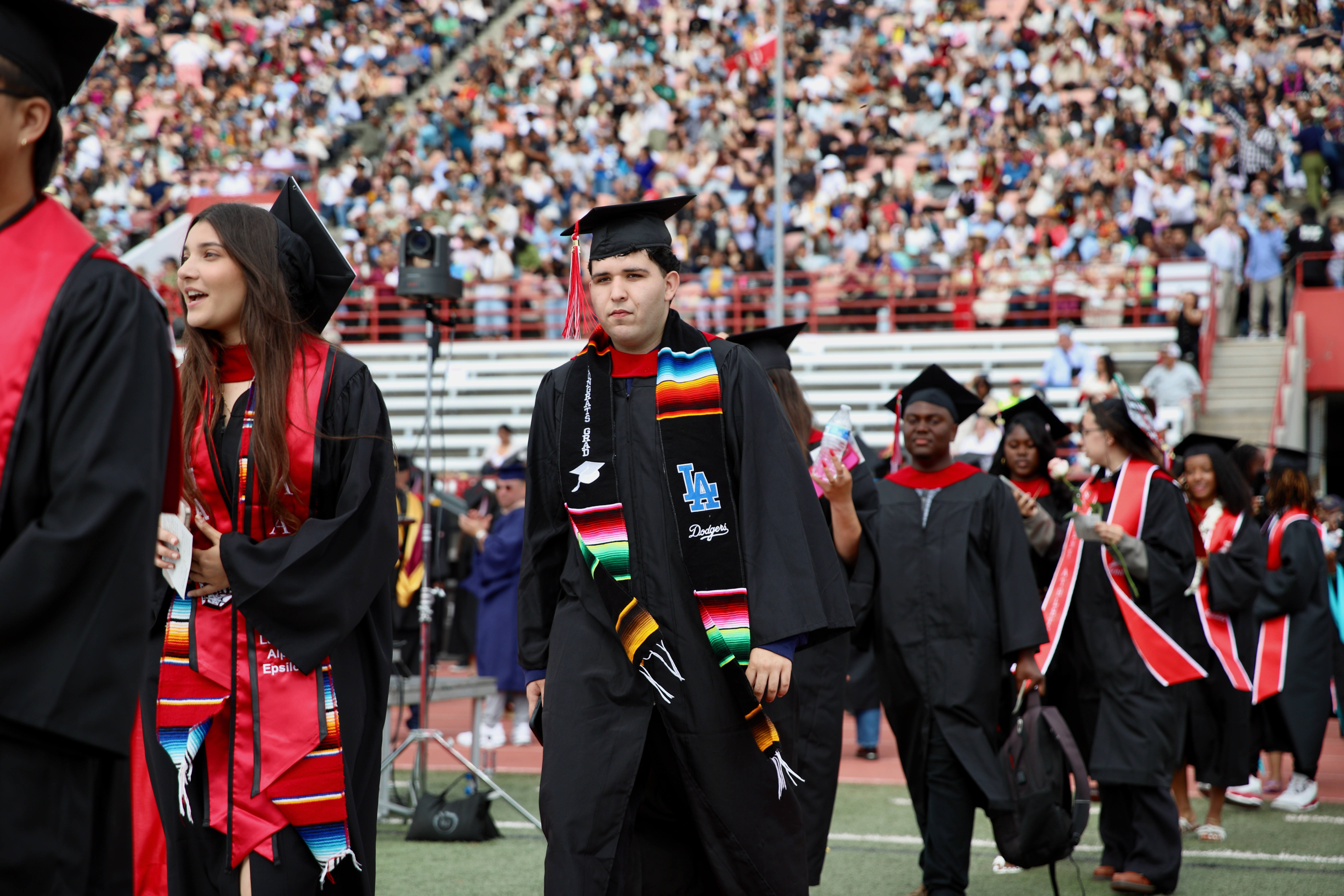 Graduating students enter the field to loud cheers at Long...