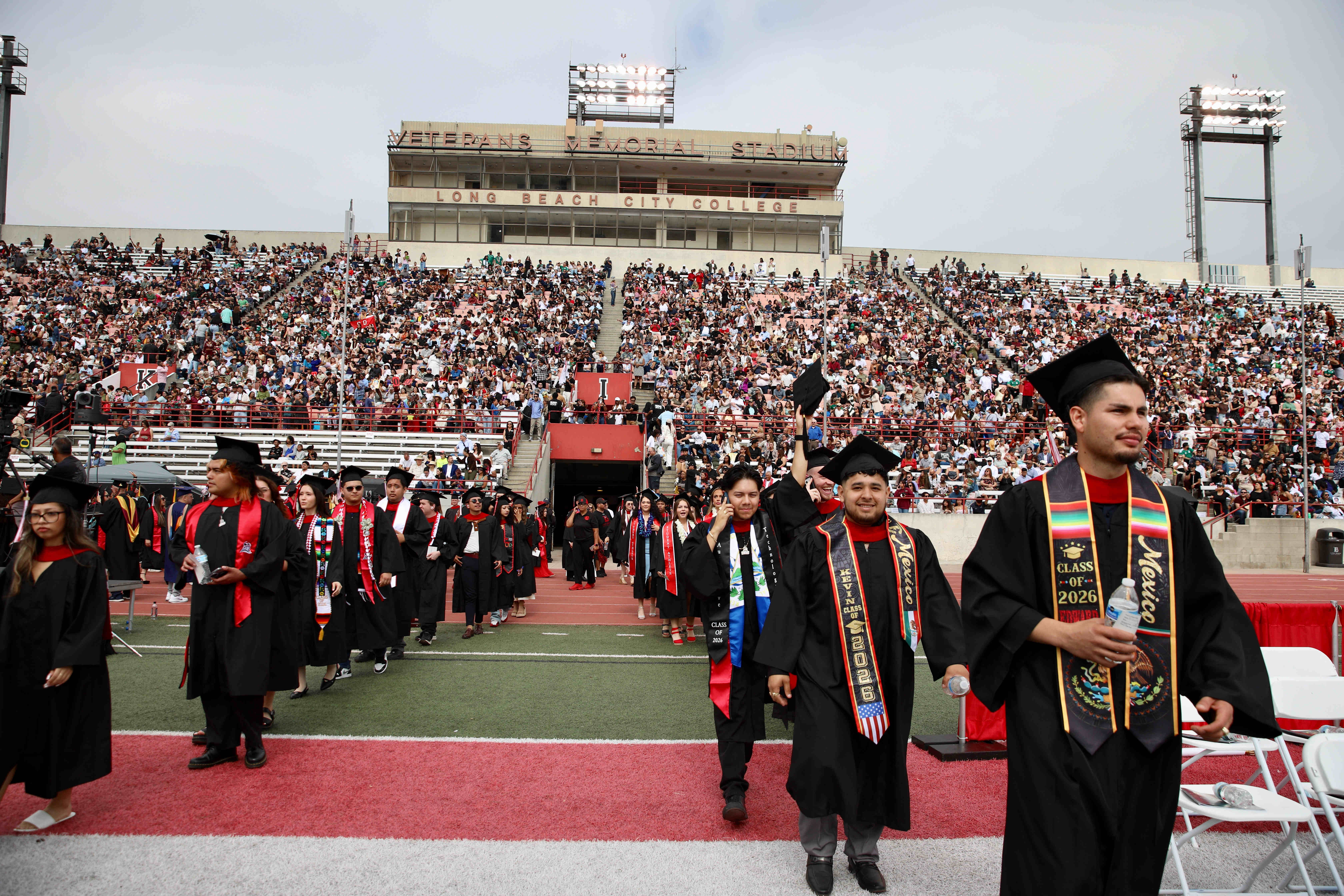 Graduating students enter the field to loud cheers at Long...