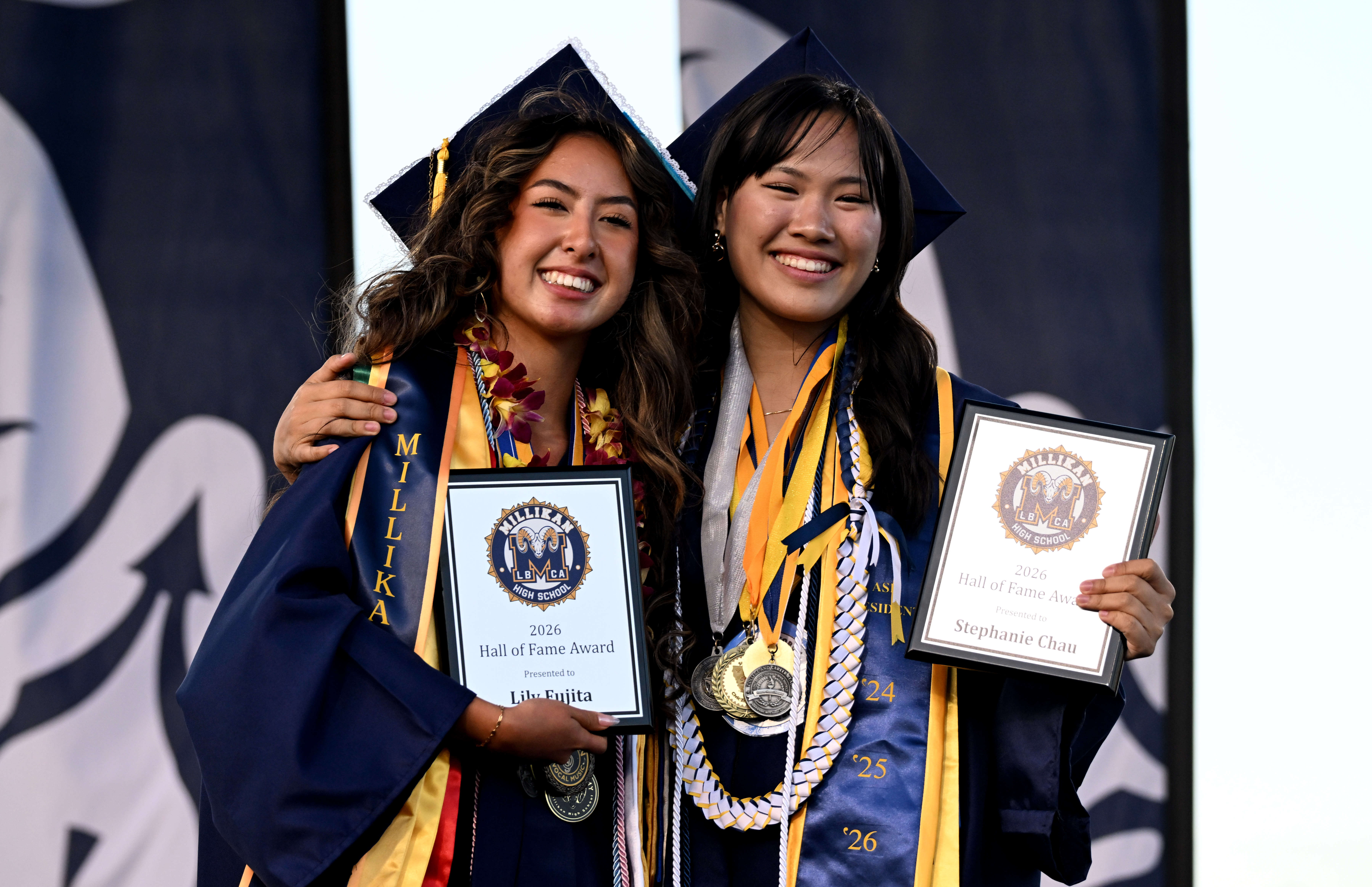 Seniors Lily Fujita, left, and Stephanie Chau, right, pose for...