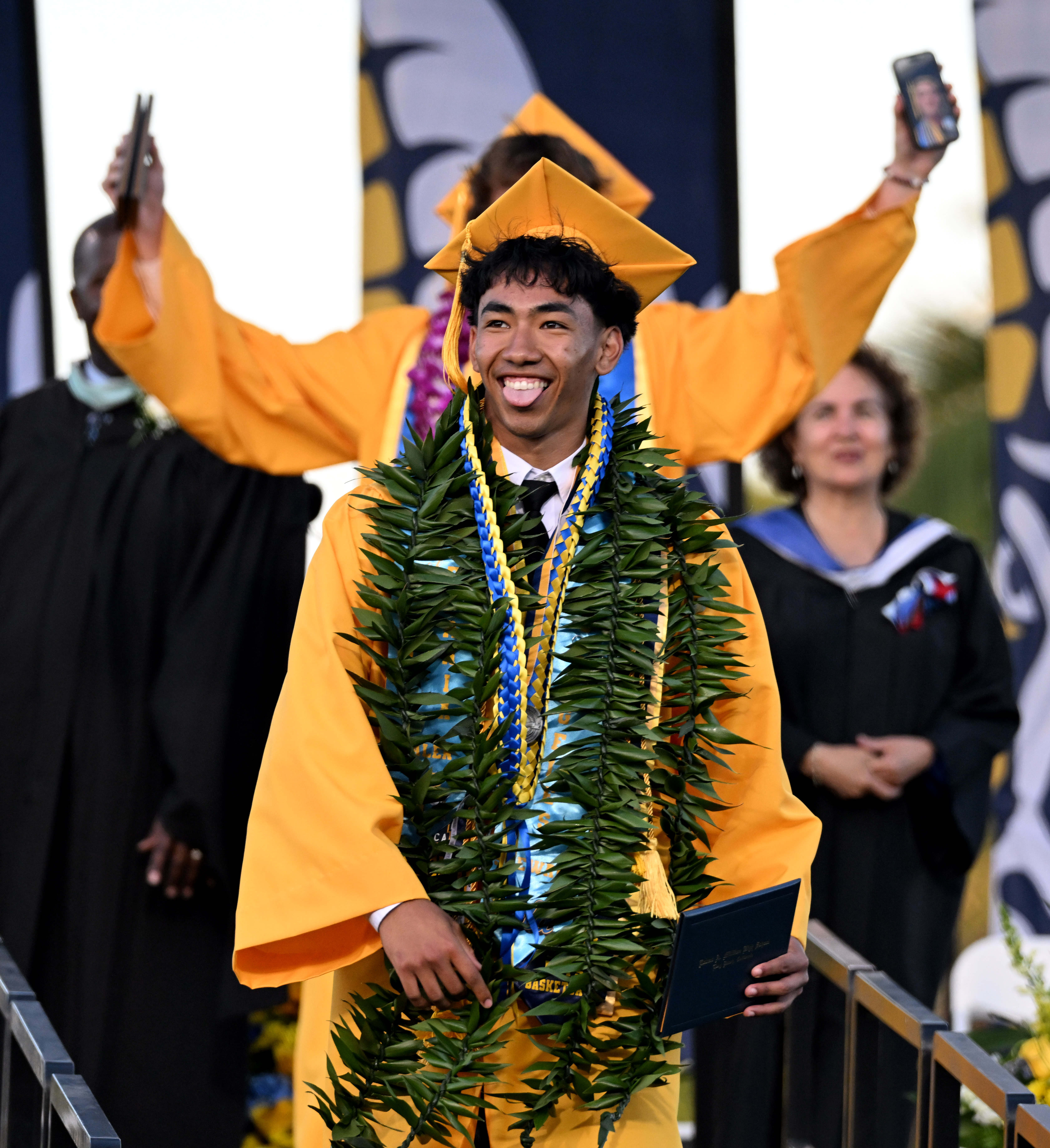 A senior celebrates after receiving his diploma during the 2026...