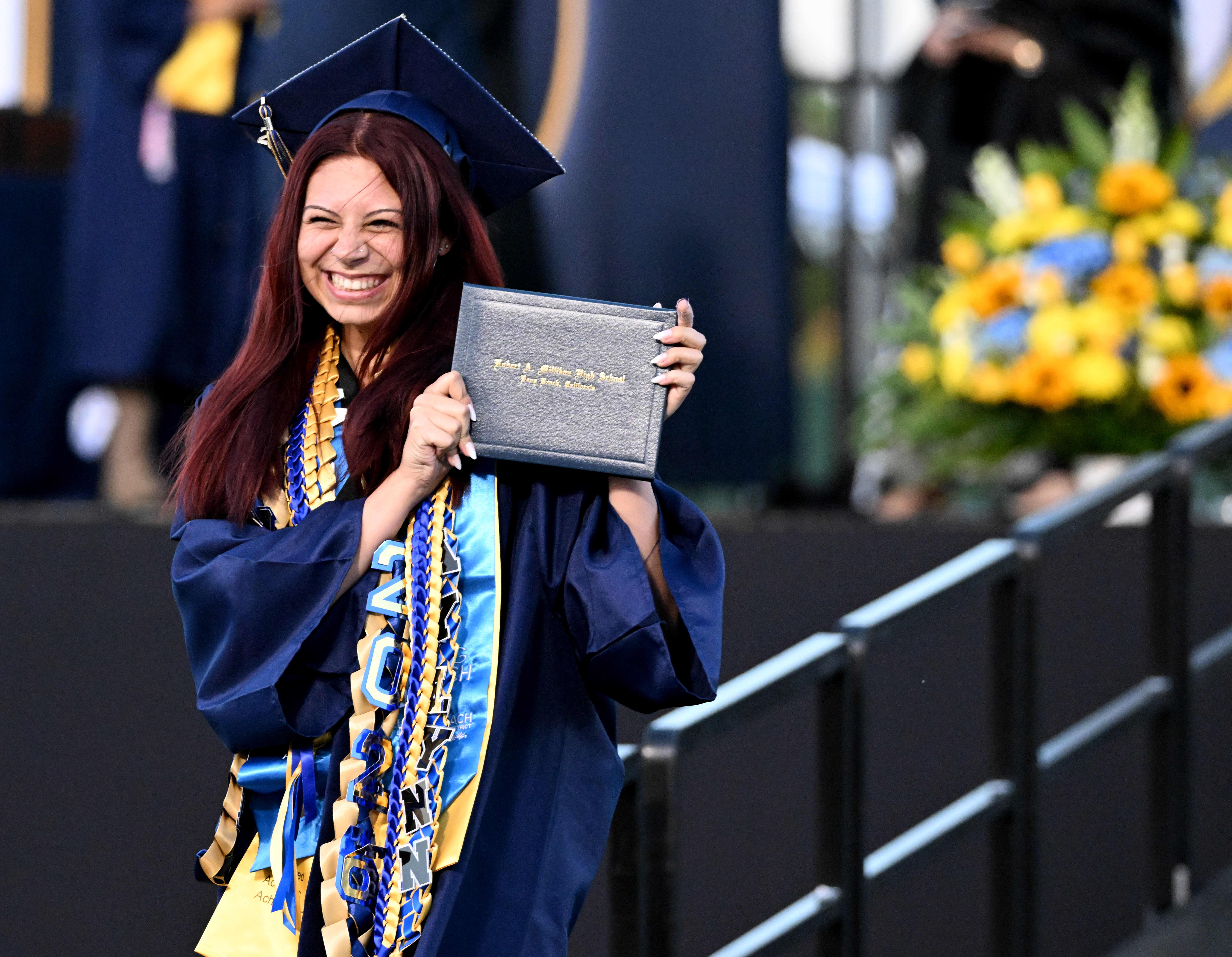 A senior smiles after receiving her diploma during the 2026...