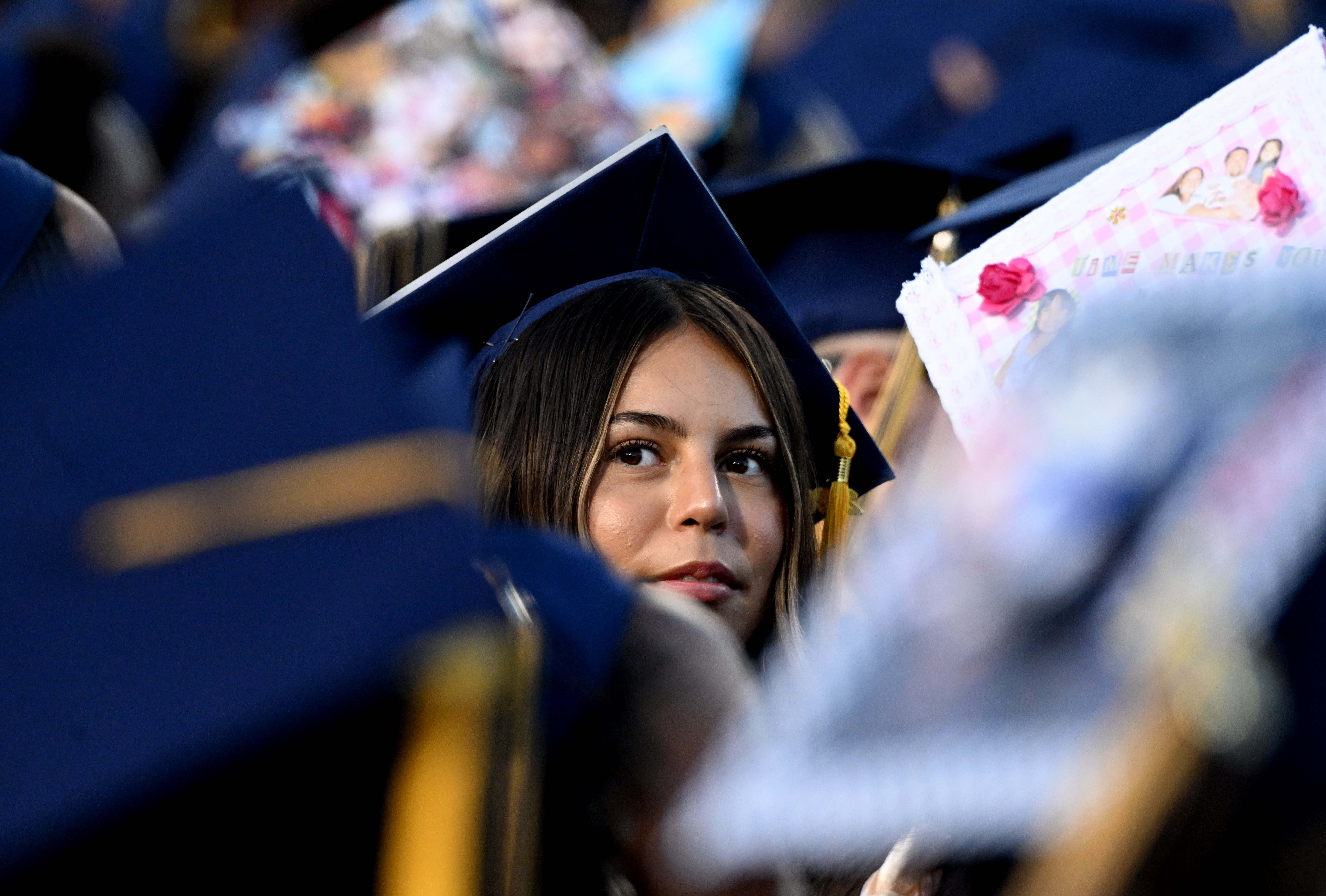 A student looks back towards her family during the 2026...