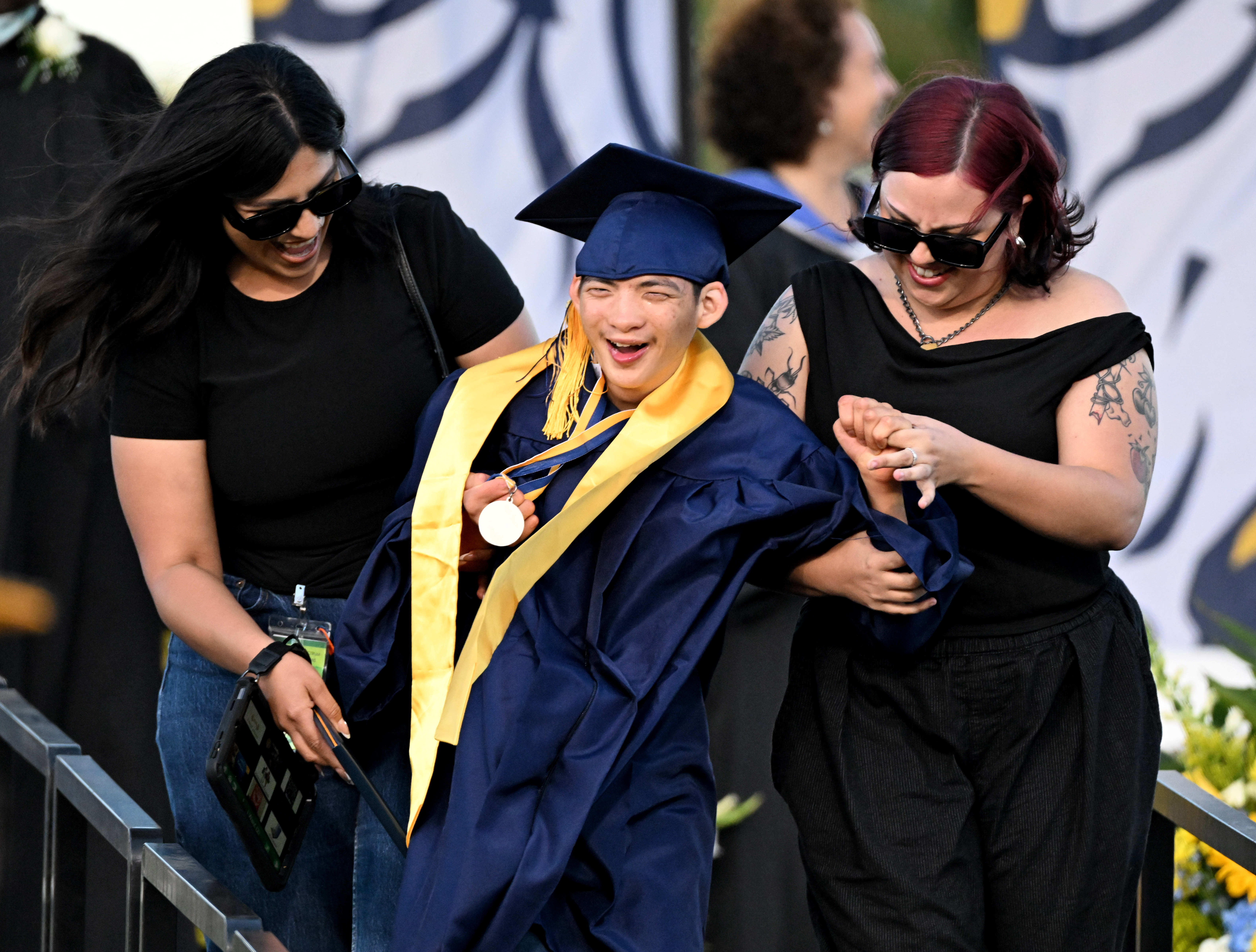 A senior smiles after receiving his diploma during the 2026...