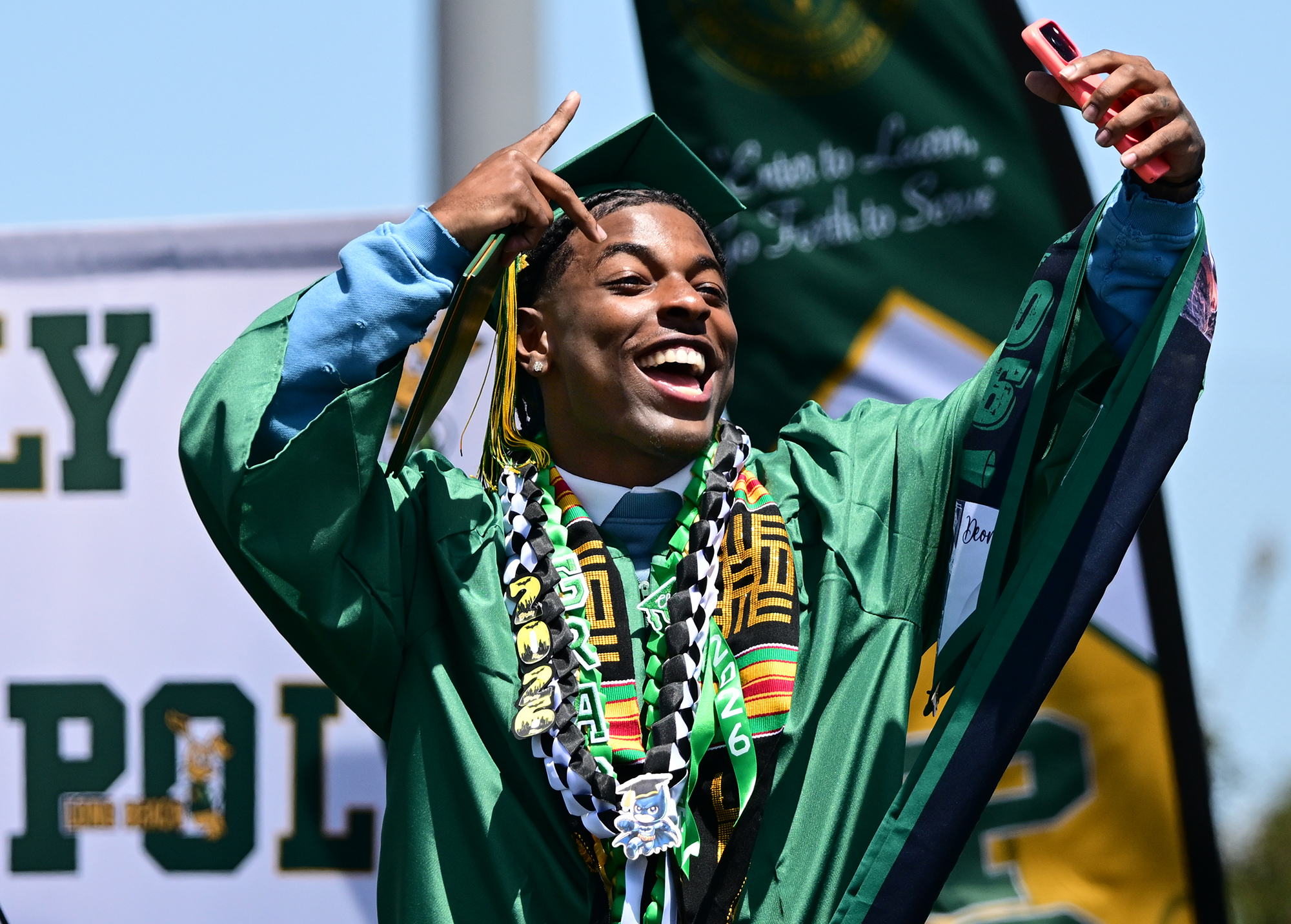 Deon Jackson records himself during the Poly High School graduation...