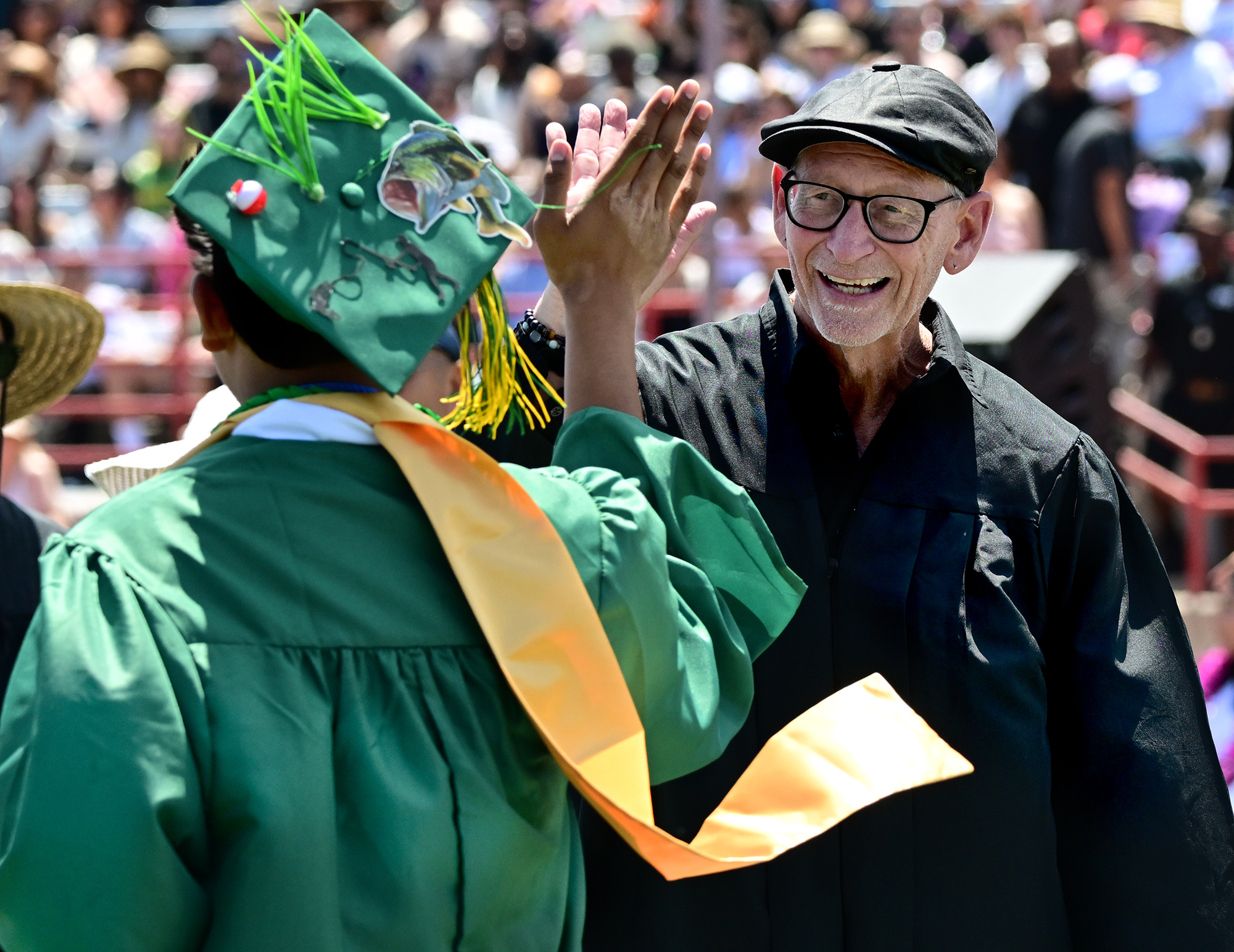 Michael Gray congratulates students after they received their diploma during...