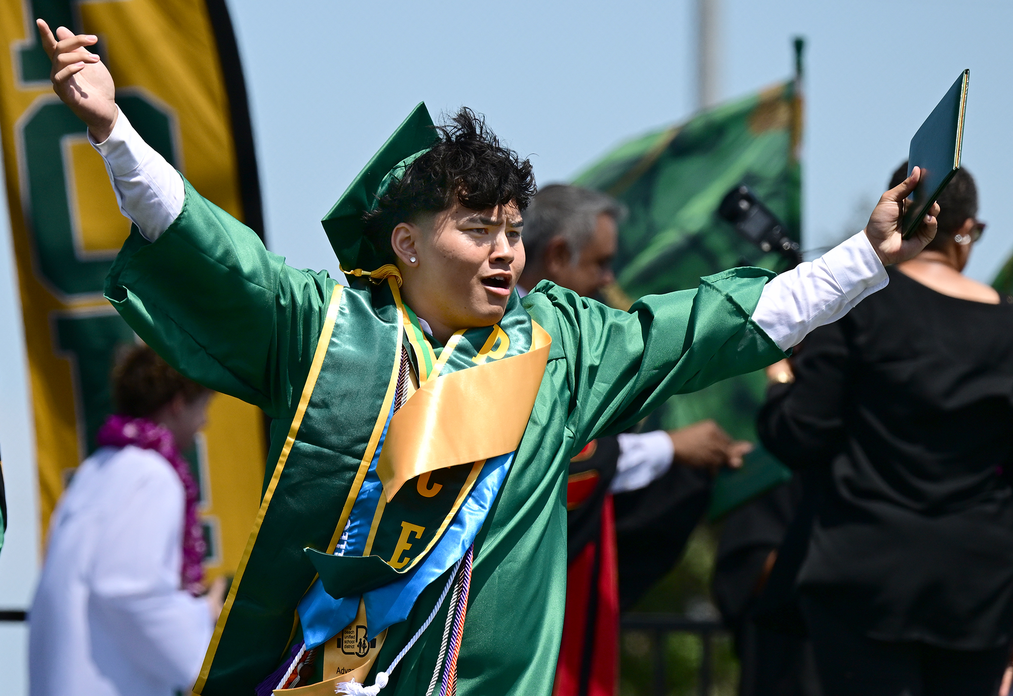 John Chaney celebrates after receiving his diploma during the Poly...