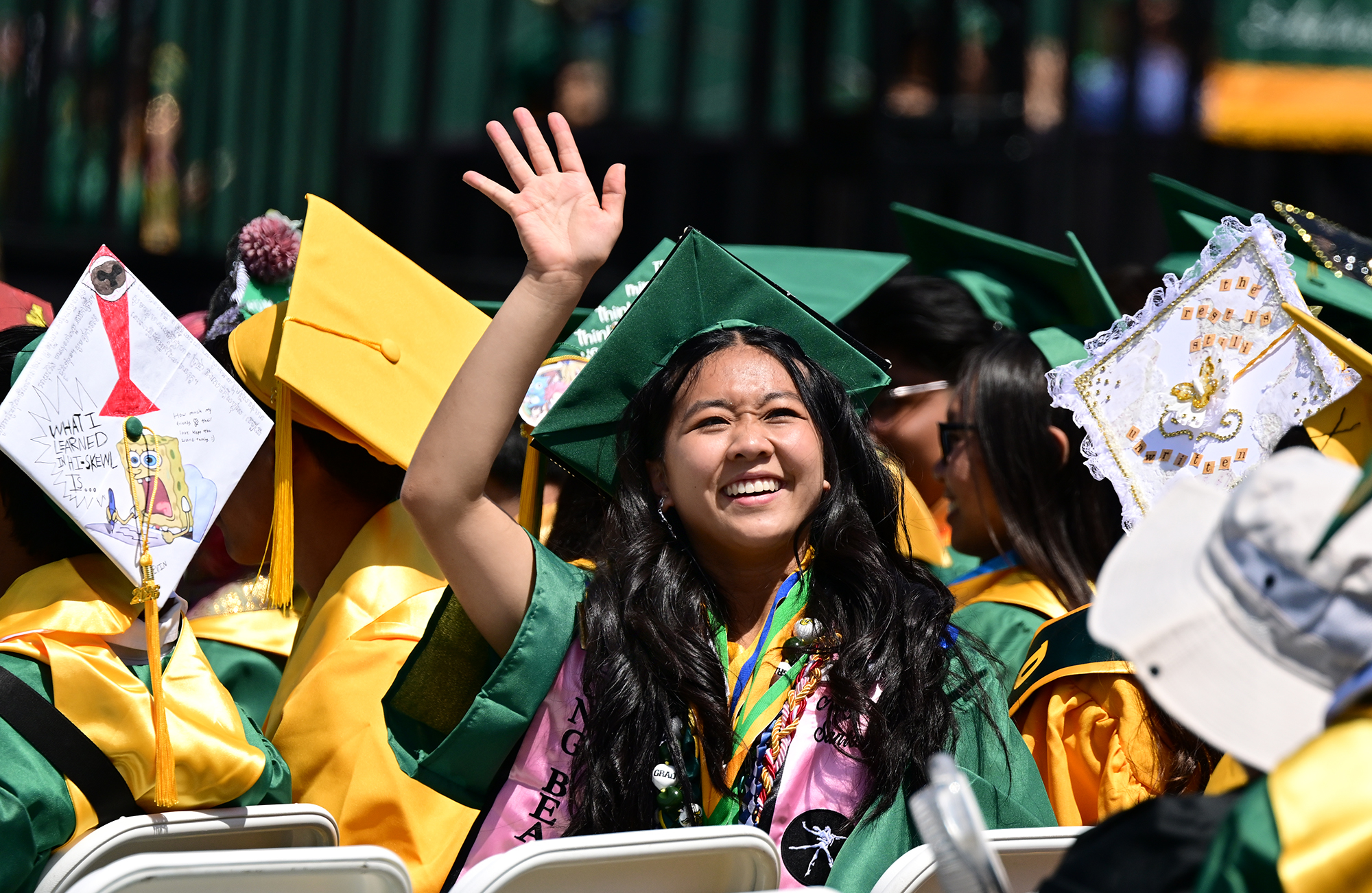 Alayna Santos waves to her family during the Poly High...
