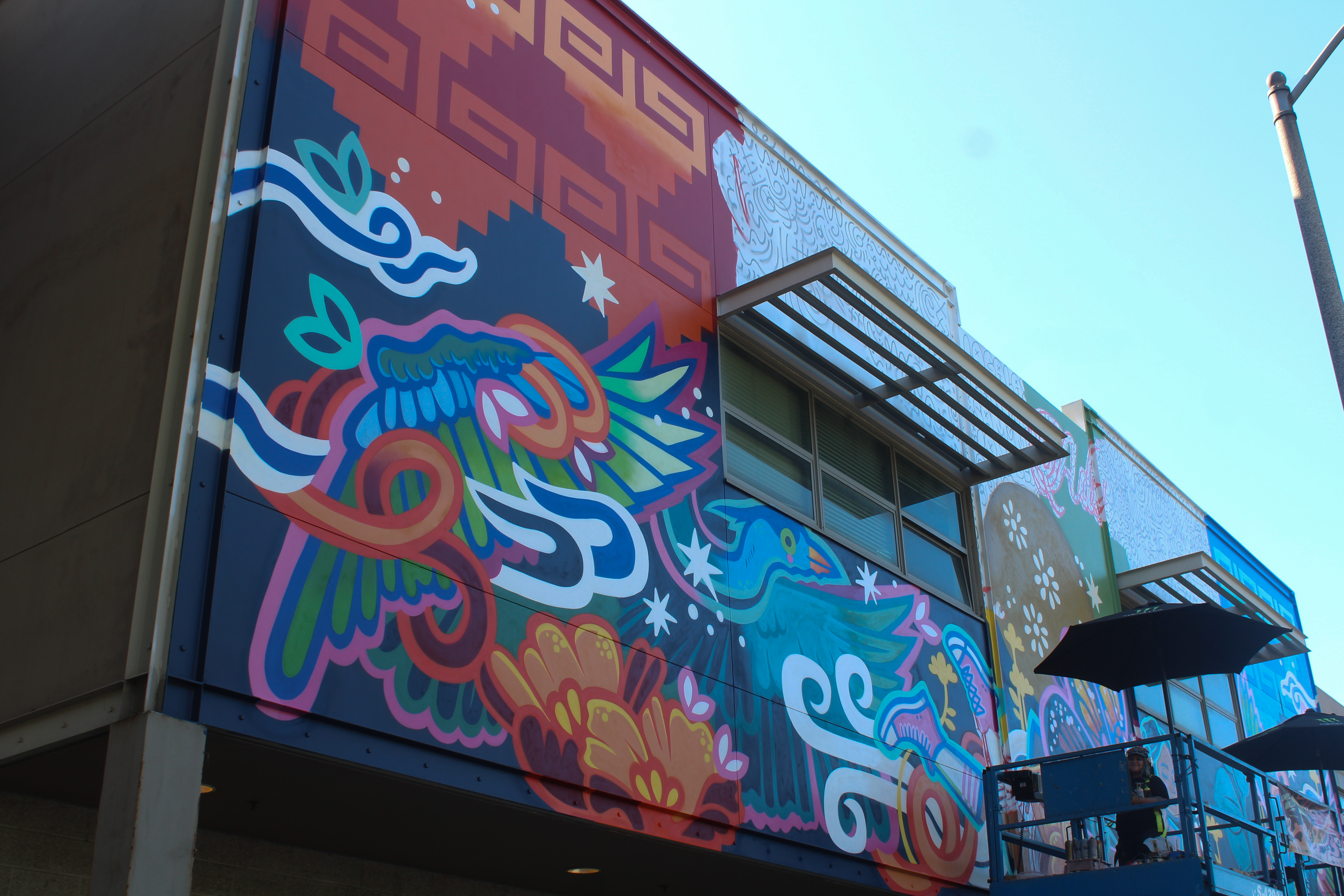 Ms. Yellow, a local Los Angeles-based muralist, finishing up a...