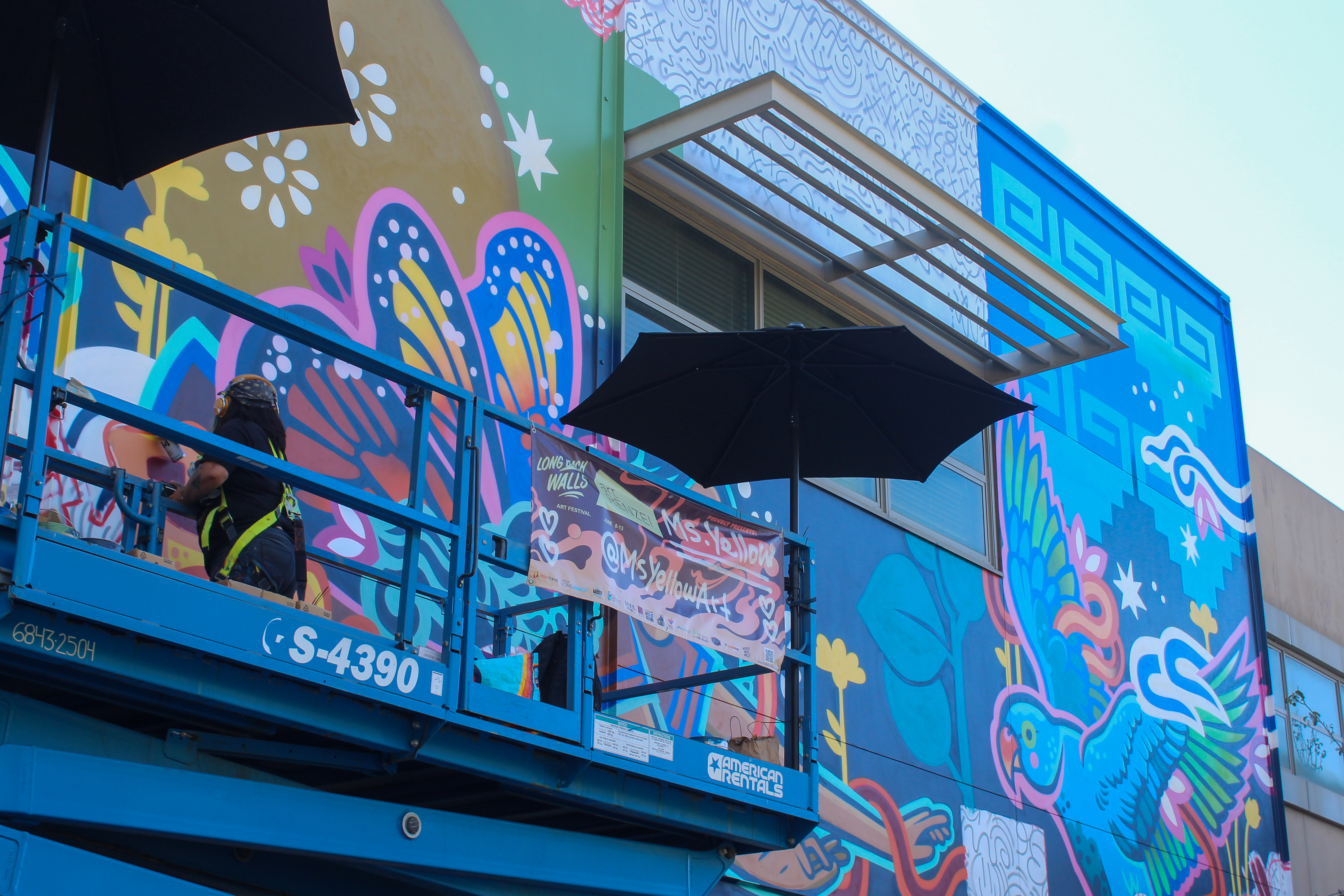 Ms. Yellow, a local Los Angeles-based muralist, finishing up a...