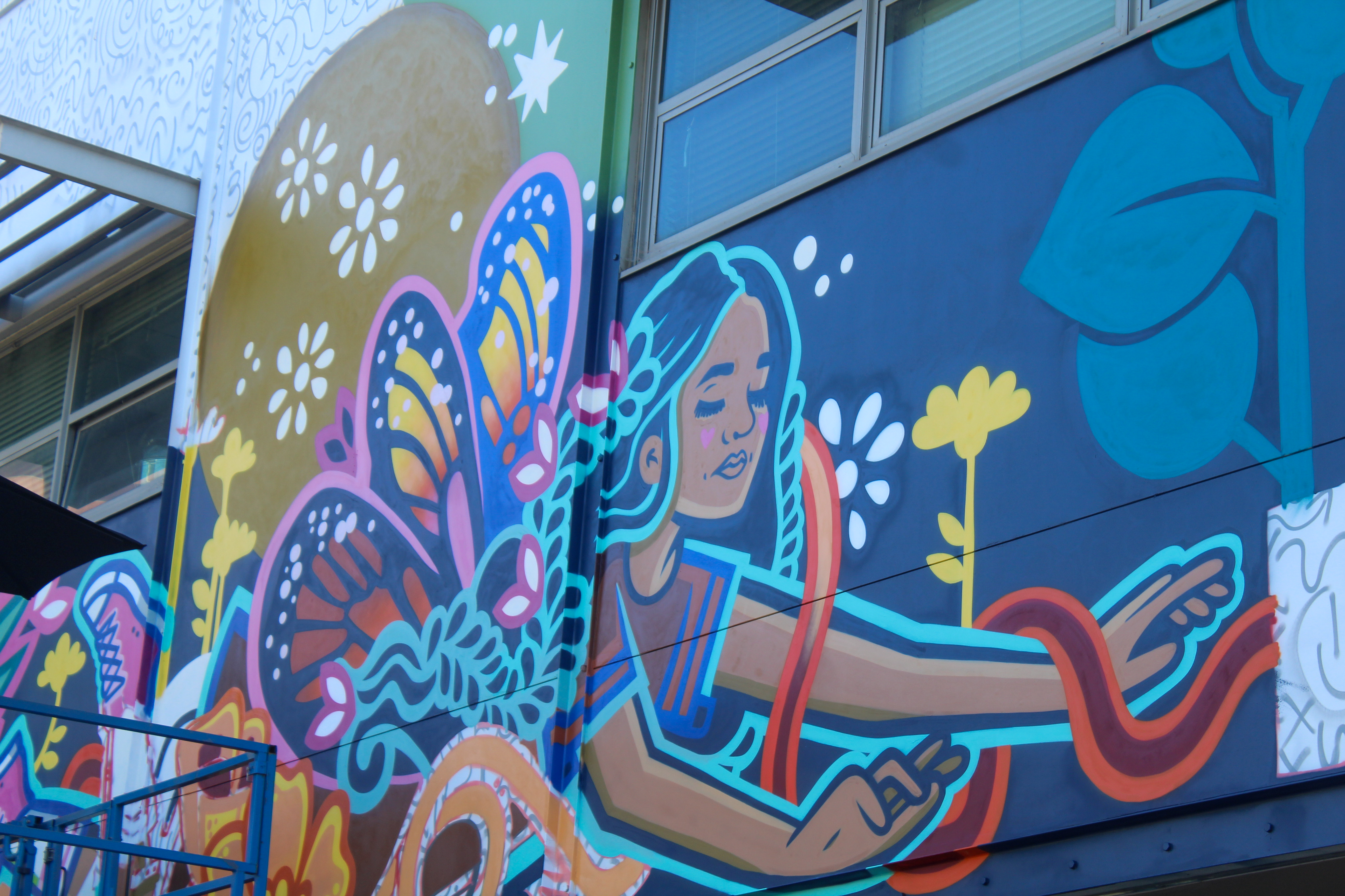 Ms. Yellow, a local Los Angeles-based muralist, finishing up a...