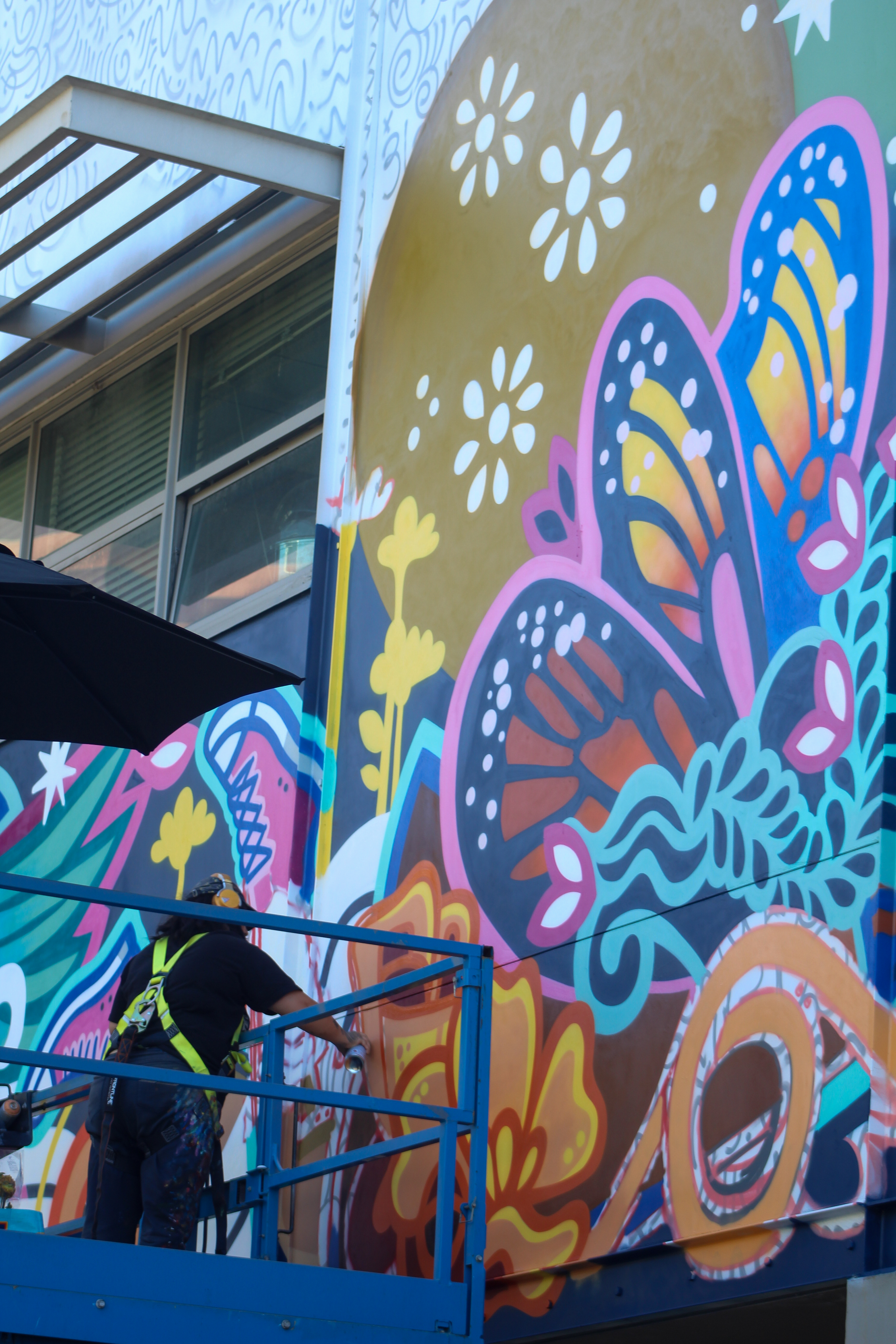 Ms. Yellow, a local Los Angeles-based muralist, finishing up a...