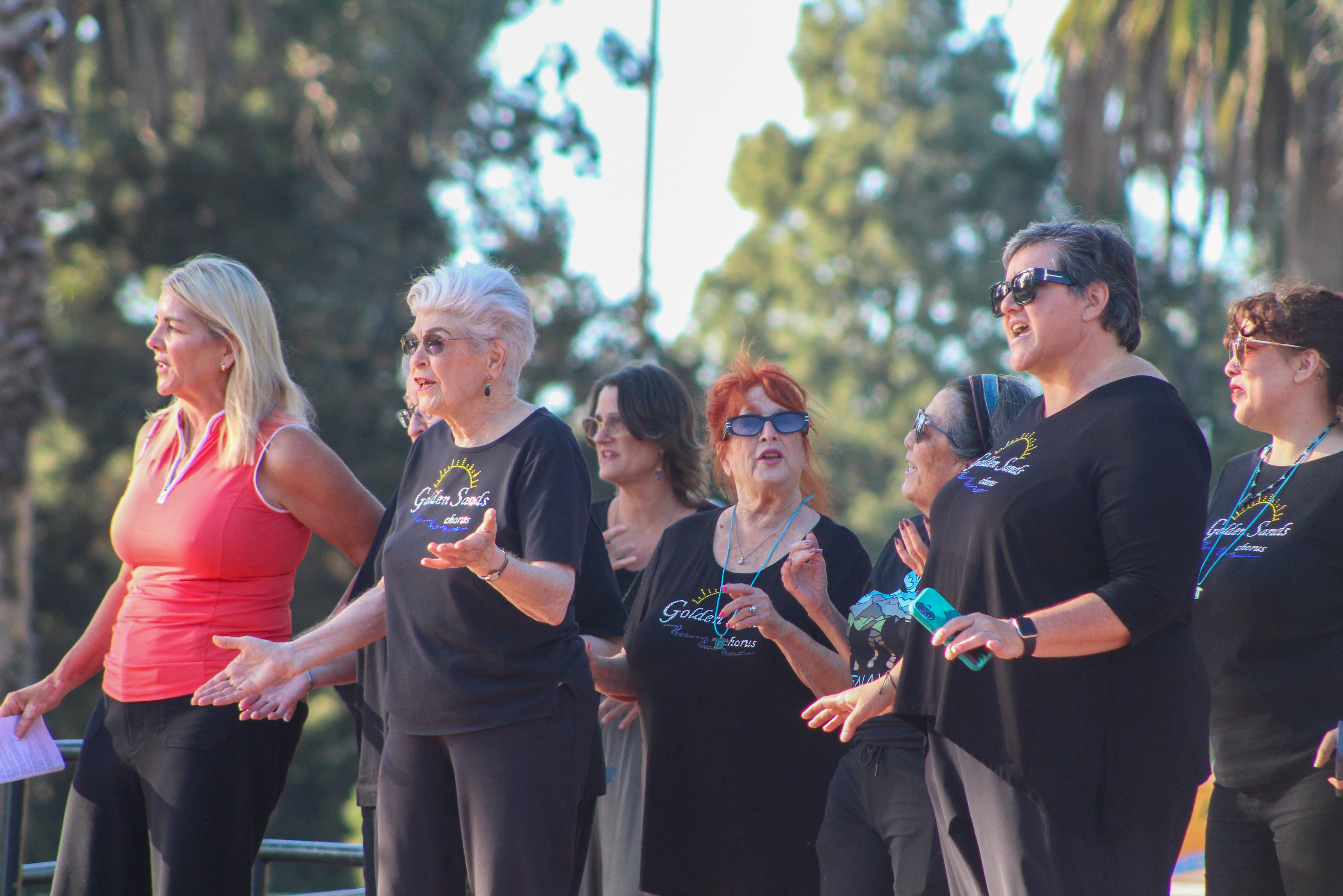 The Golden Sands Chorus, joined by Third District Councilmember Kristina...