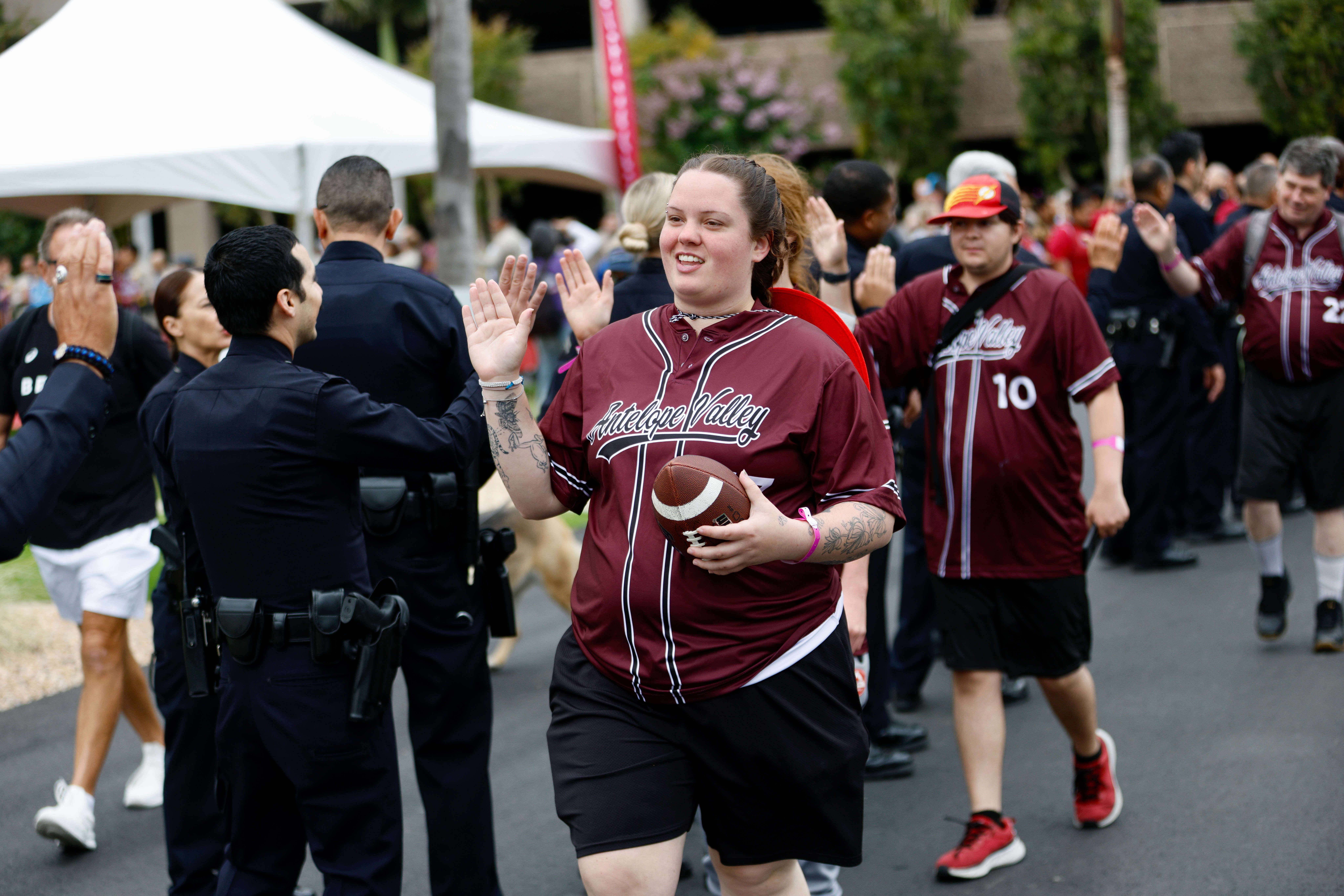 Athletes are greeted by scores of law officers as they...