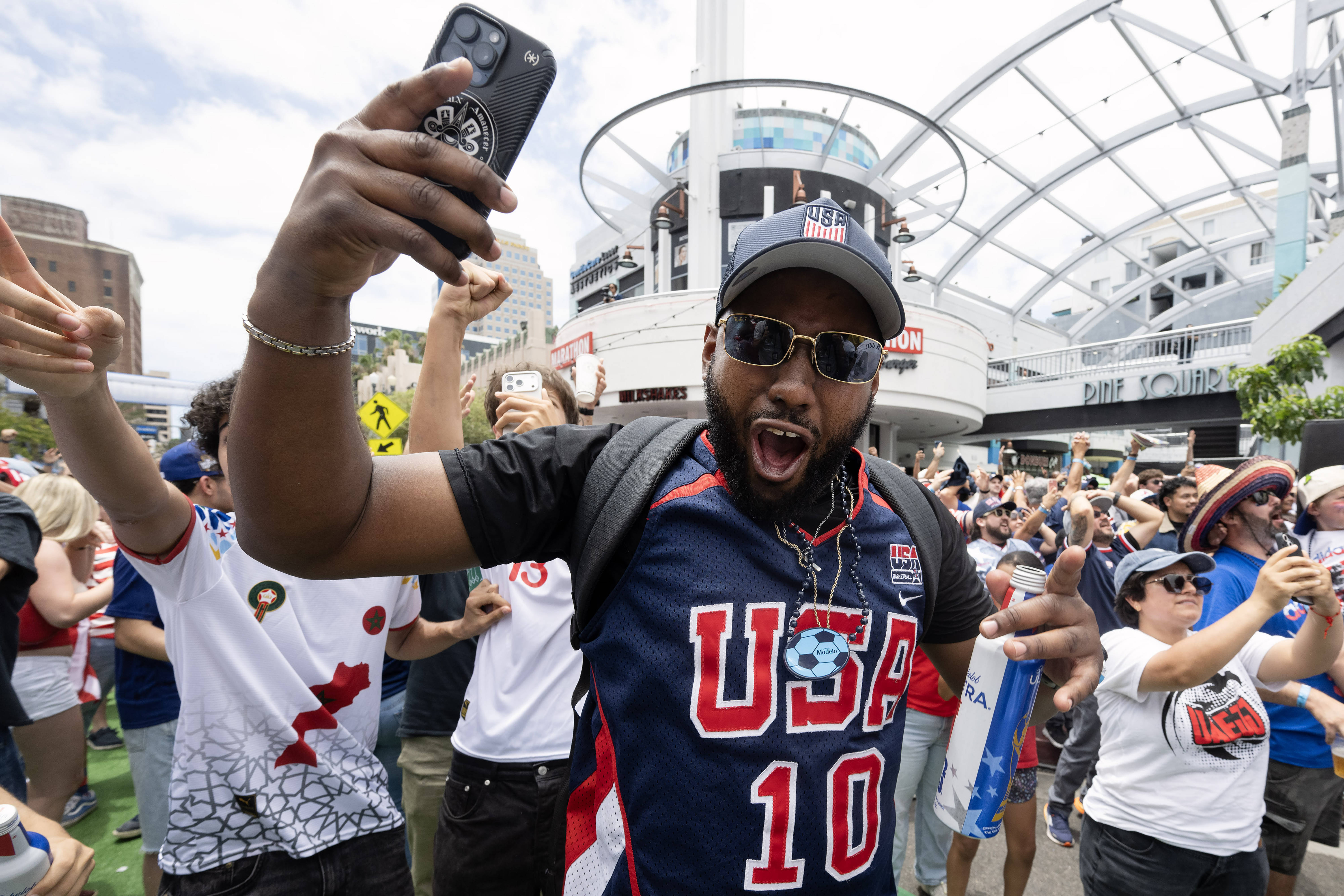 U.S.A. soccer fan Rolando Rhymes celebrates their second goal against...