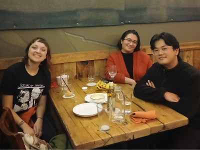 three students at restaurant table