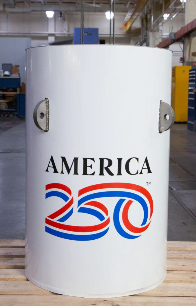 shiny white cylinder labeled AMERICA 250; the 250 is a red, white and blue ribbon