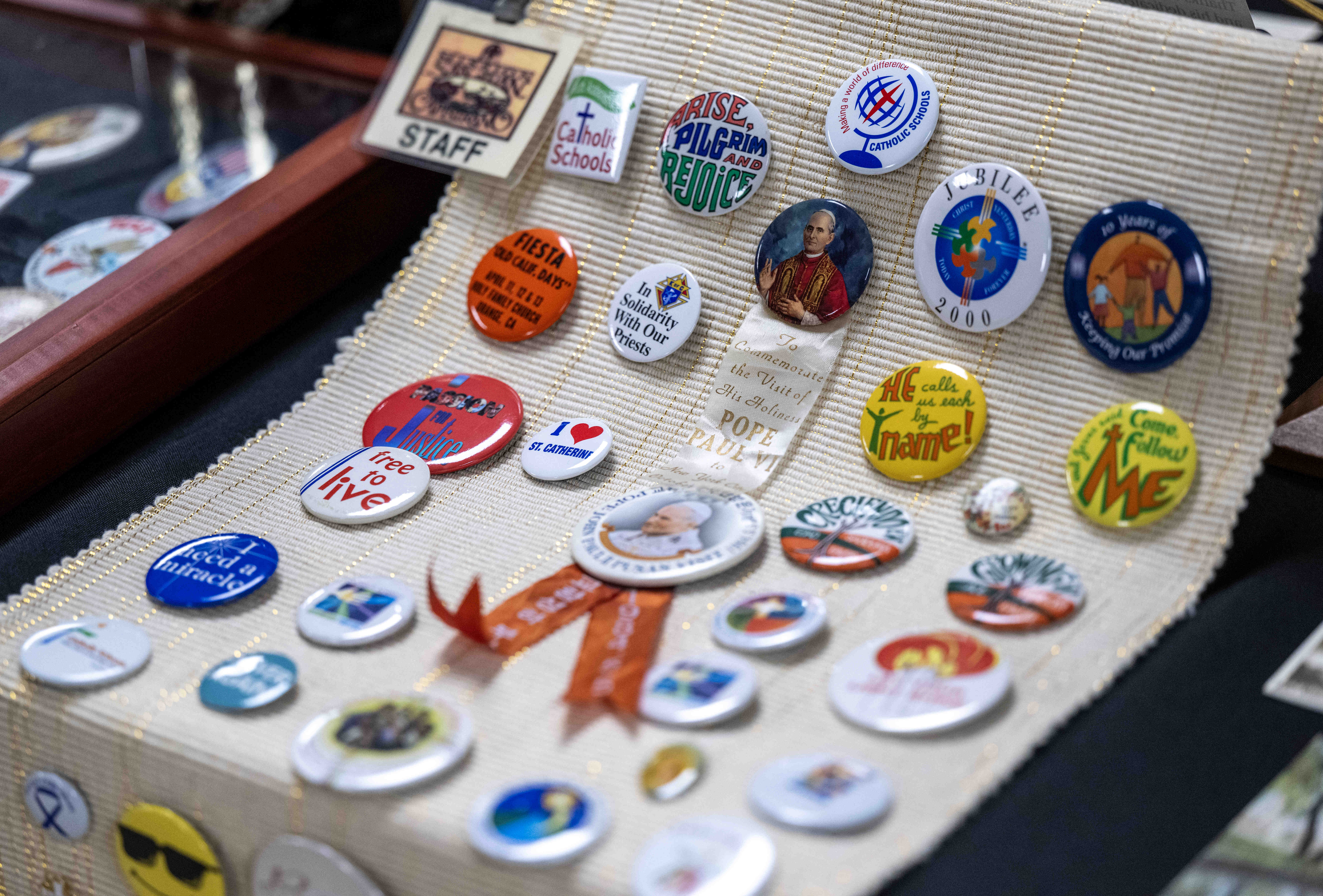 A collection of Catholic buttons sits on display in a...