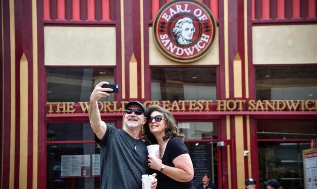 Steve Tolle and his wife, Emily Tolle, take a selfie in front of the re-opened Earl of Sandwich in the Downtown Disney District at the Disneyland Resort in Anaheim, CA, on Monday, Oct 1, 2018. (Photo by Jeff Gritchen, Orange County Register/SCNG)